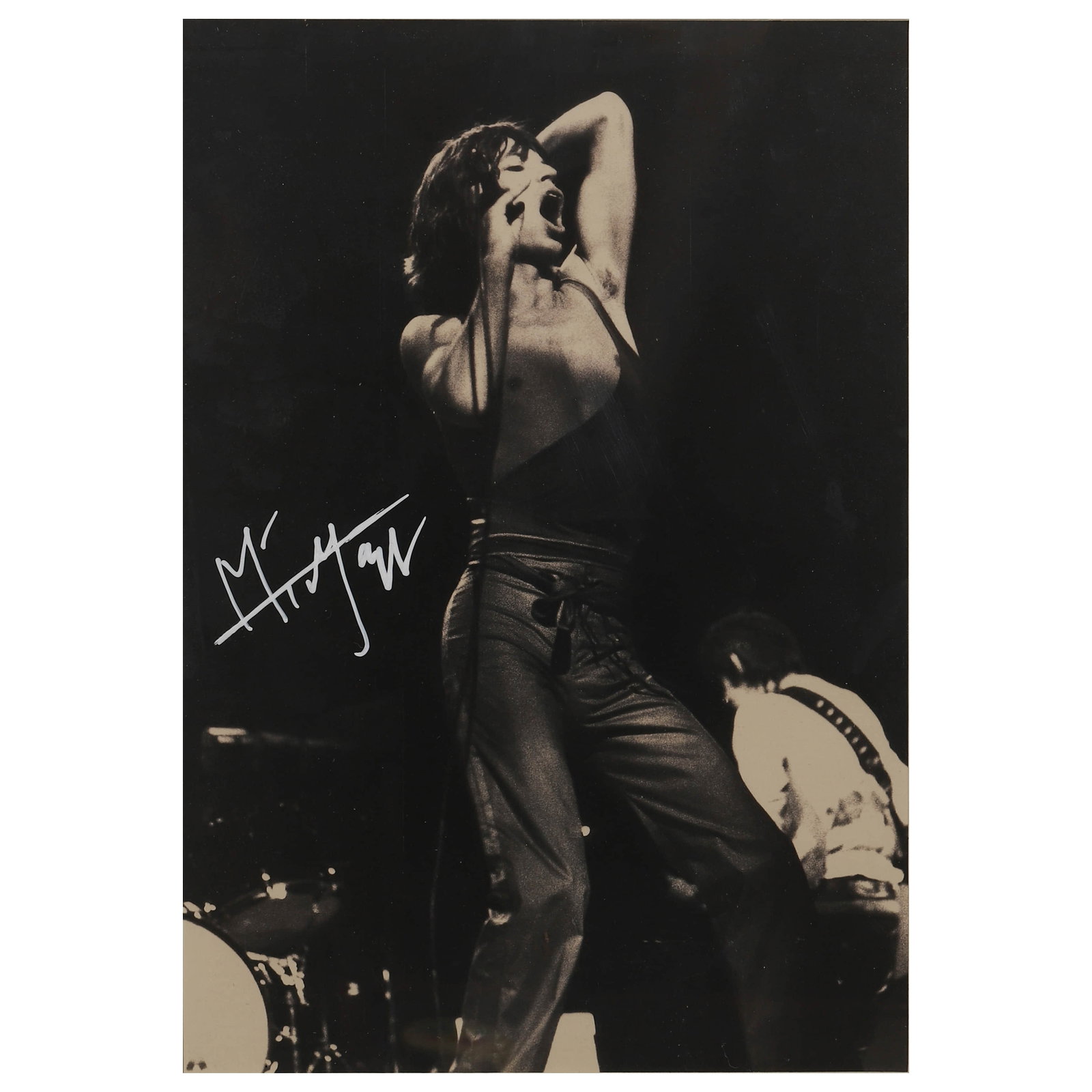 MICK JAGGER ON STAGE: Description Title: Mick Jagger on Stage Materials: Gelatin silver print, mounted on board Signature: Signed "Mick Jagger" in white ink on the left side Size: Photograph 9 1/2 x 13 15/16 in. (24.1 x 35
