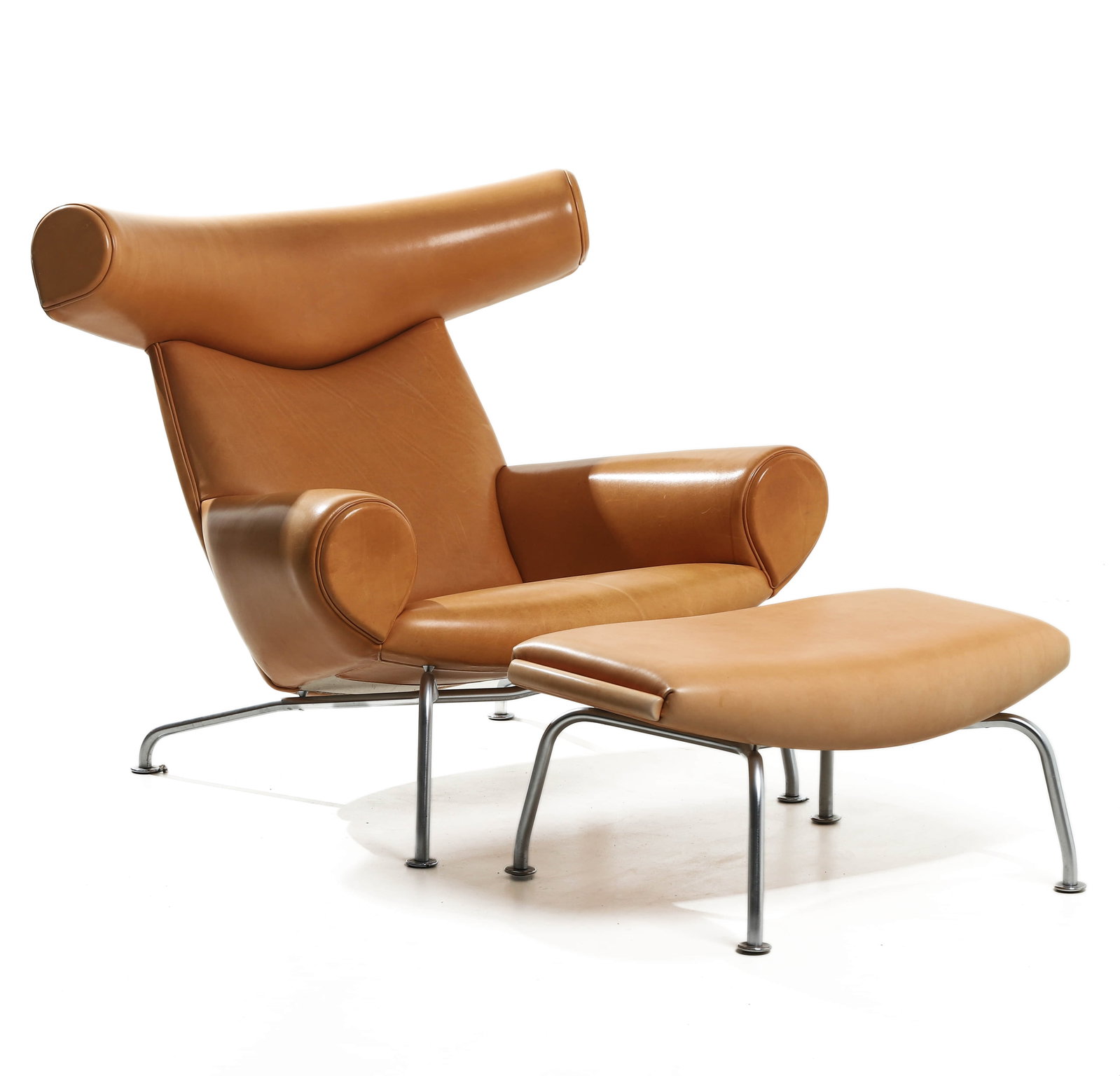 HANS J. WEGNER "OX" CHAIR AND OTTOMAN FOR ERIK J?RGENSEN, 1960: Dimensions Chair: Height 34 1/4 in. (87 cm), Seat height 13 3/4 in. (35 cm), Width 37 13/16 in. (96 cm); Ottoman: Length 29 1/2 in. (75 cm), Width 17 11/16 in. (45 cm), Height 14 3/16 in. (36 cm) Desc