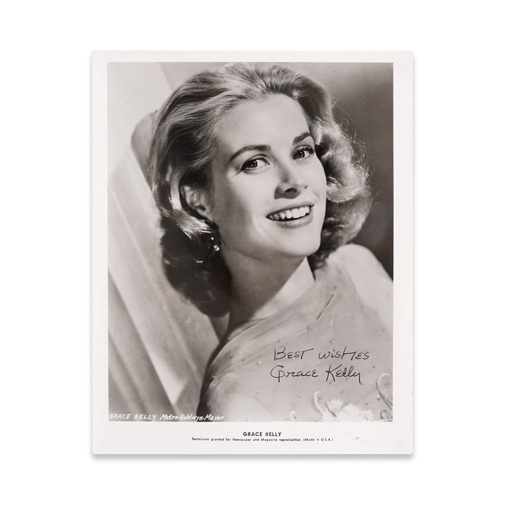 GRACE KELLY SIGNED PUBLICITY PHOTOGRAPH WITH INSCRIPTION: 10 1/8 x 8 in (25.7 x 20.4 cm) Provenance and Authentication: This lot is accompanied by supporting documentation provided by the consignor. According to the accompanying materials, the signature was