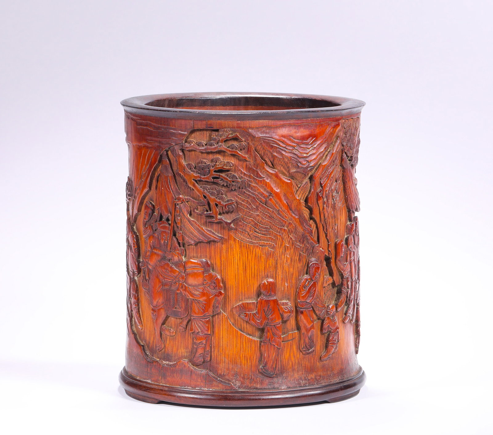 A BAMBOO PEN HOLDER WITH A FIGURE ON THE MOVE FROM THE QING DYNASTY: H:16.5cm(6.50in) D:14.3cm(5.63in) Weight:510g(1.12lb)This brush pot is a masterpiece of Jiading School bamboo carving in the Qing Dynasty. Carved from high-quality aged bamboo root, it features a warm