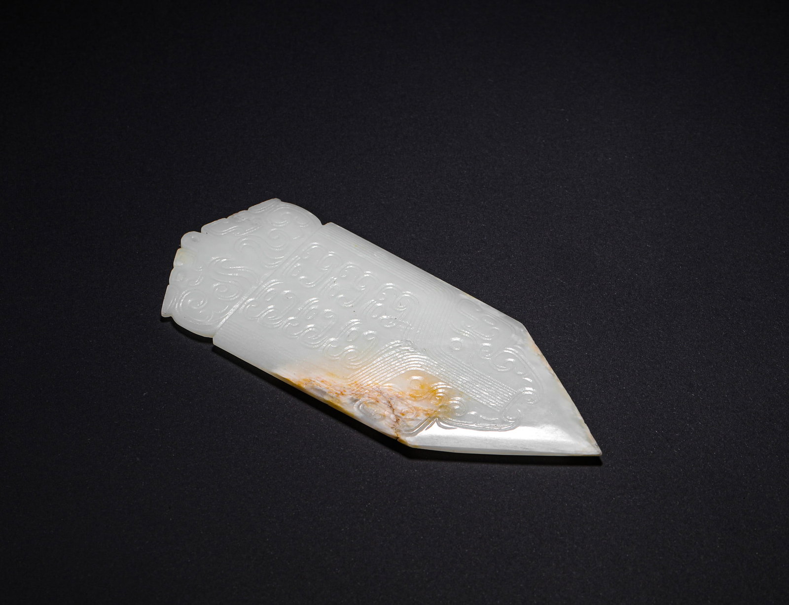 HAN DYNASTY HETIAN JADE PENDANT WITH ANIMAL FACE PATTERN: H:13.5cm(5.31in) W:5.5cm(2.17in) Weight:90g(0.20lb)This jade gui is a masterpiece of Han Dynasty ancient jade craftsmanship. Carved from top-quality Hetian white jade, it features a warm, white textur