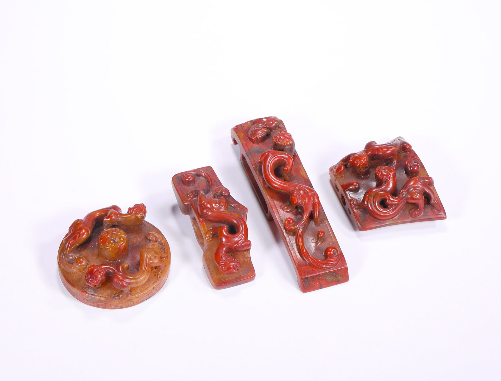 HAN DYNASTY WARRING STATES PERIOD RED AGATE HIGH RELIEF DRAGON PATTERN SWORD ORNAMENT: H:5.5cm(2.17in) Weight:280g(0.62lb)This set of sword ornaments is a national treasure of ancient agate craftsmanship in the Han Dynasty. Made of high-quality Zhanguo red agate, it features a warm and