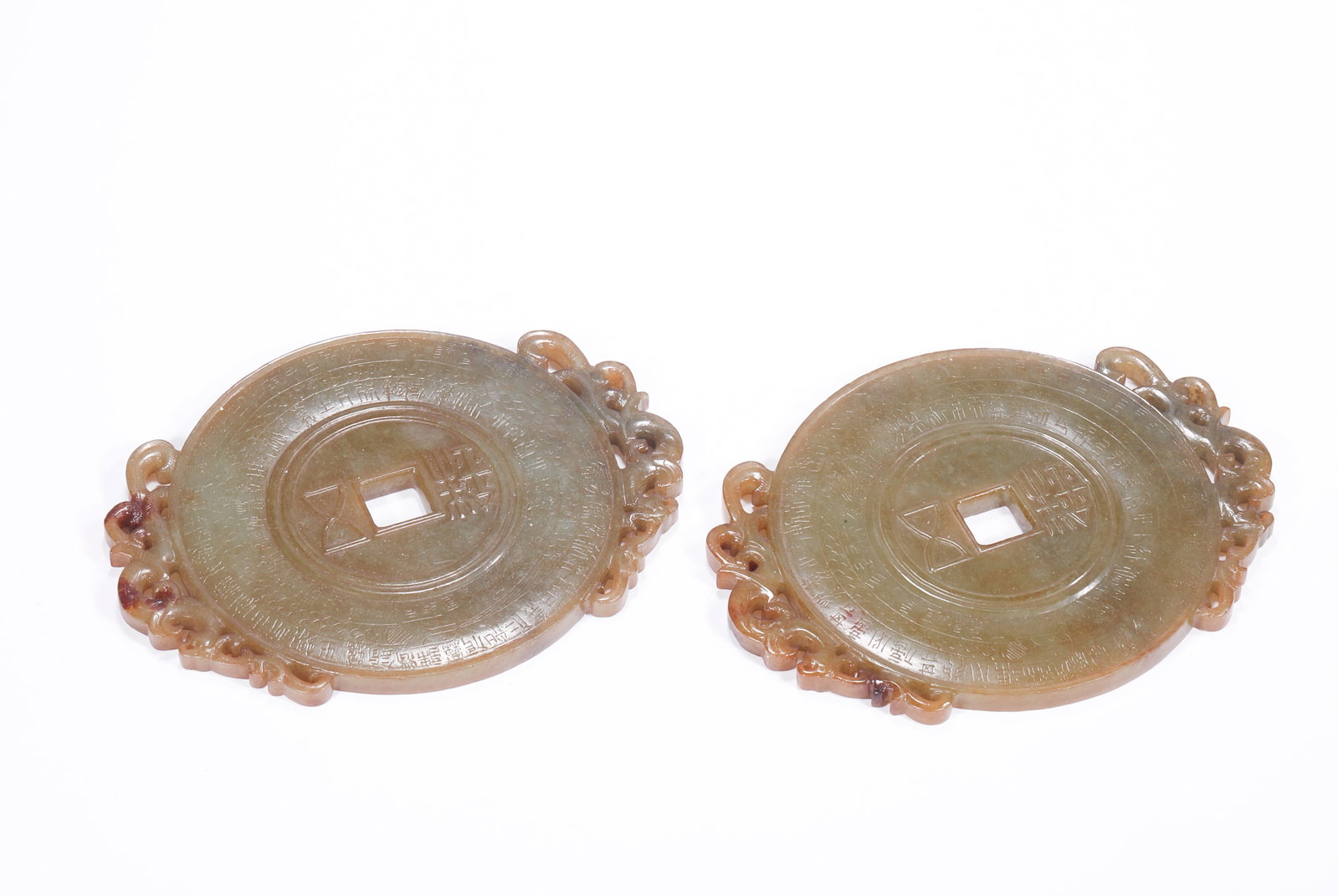 HAN DYNASTY HETIAN JADE COIN PATTERN OUTLINE BI: H:10cm(3.94in) W:13cm(5.12in) Weight:310g(0.68lb)This pair of jade bi discs is a masterpiece of ancient jade in the Han Dynasty. Made of Hetian jade, it forms a warm brown patina after long-term