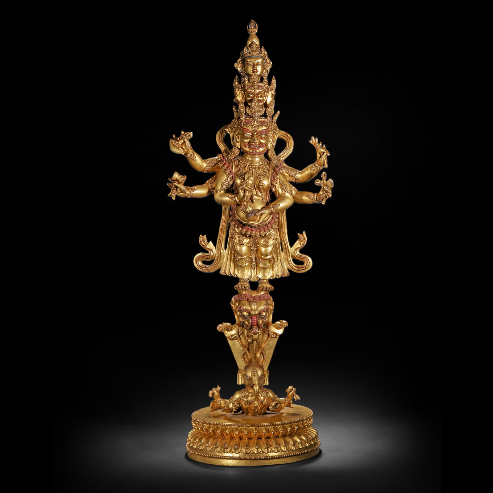 A GILDED BRONZE SIX-ARMED MAHAGALA STATUE FROM THE QING DYNASTY: H:78.0cm(30.71in) W:27.0cm(10.63in) Weight:13400g(29.54lb)This statue is cast in bronze and gilded. The main figure White Six-Armed Mahakala is in a wrathful form, with six arms holding implements suc