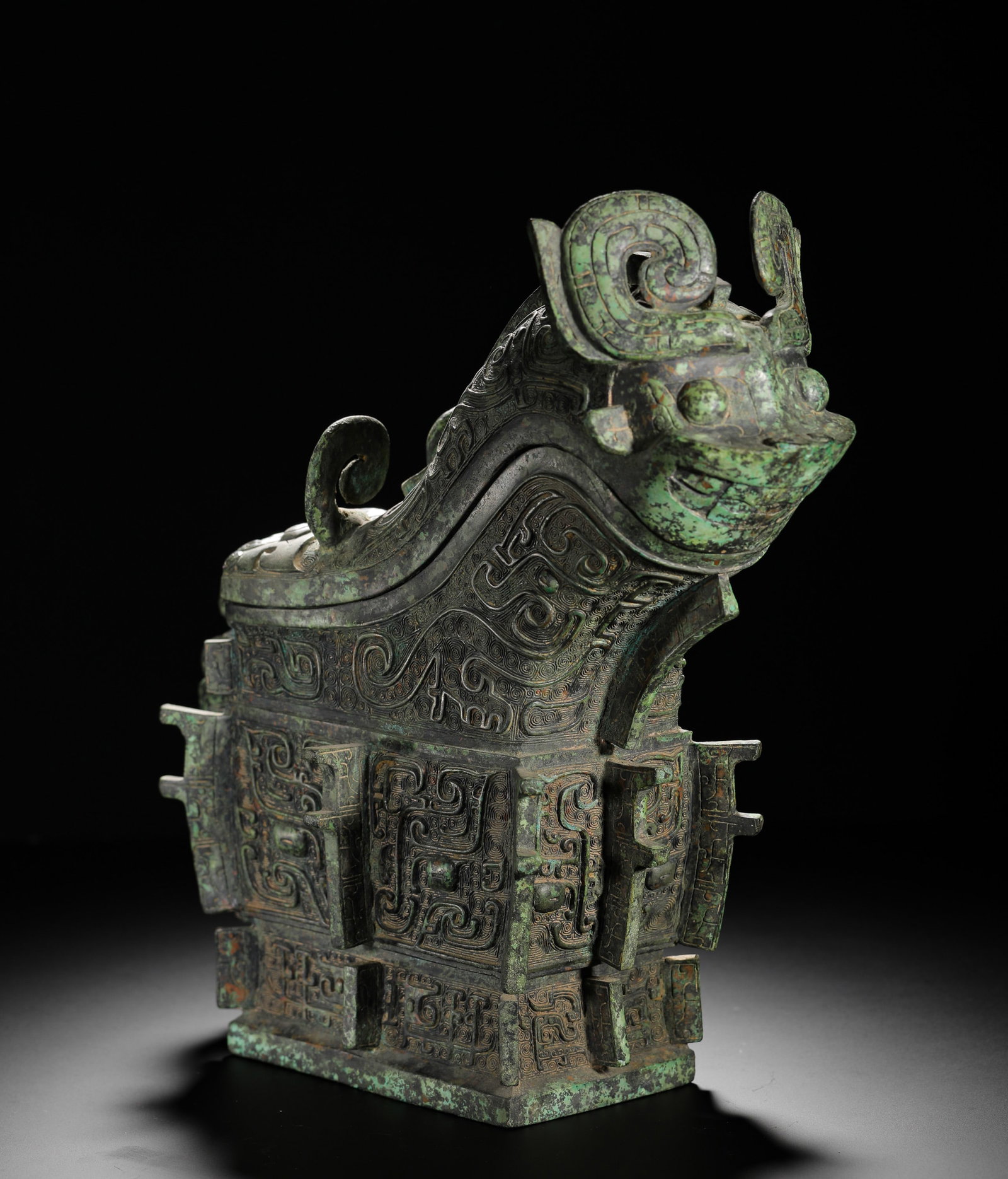 SHANG DYNASTY BRONZE BEAST SHAPE : H:31cmW:31cmWeight:5470g This is a Shang Dynasty bronze wine vessel. Shaped like a mythical beast and decorated with animal mask patterns, its exquisite craftsmanship makes it a prime example of