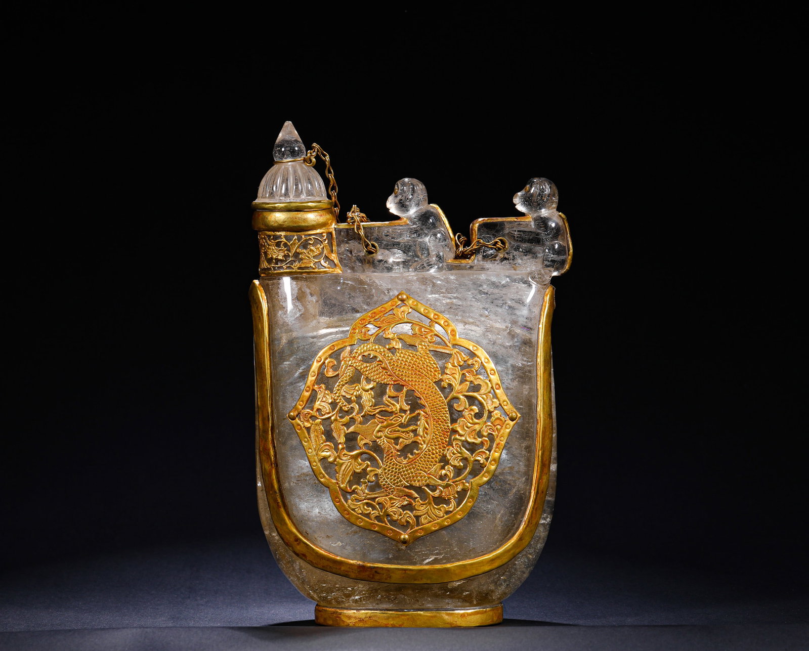 QING DYNASTY CRYSTAL WRAPPED GOLD LEATHER BAG TEAPOT: H:22cm (8.66in) W:14cm (5.51in) This is a Qing Dynasty crystal flask with gold mounting, crafted from natural crystal in the shape of a nomadic leather pouch. It is adorned with gilt chiseled dragon p
