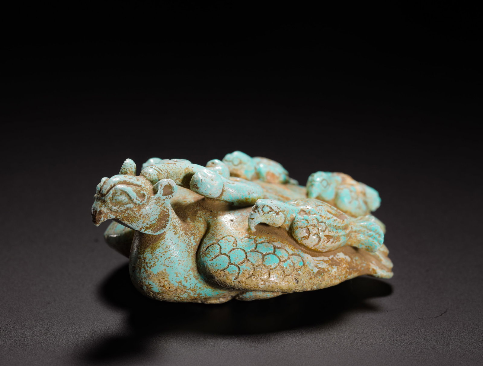 TURQUOISE PHOENIX OF THE HAN DYNASTY: H:2.8cm(1.10in)W:8cm(3.15in)Weight:70g(0.15lb)Phoenixes symbolized auspiciousness, nobility, and peace in Han culture. They were popular subjects for jade and stone carvings used as ornaments or adorn