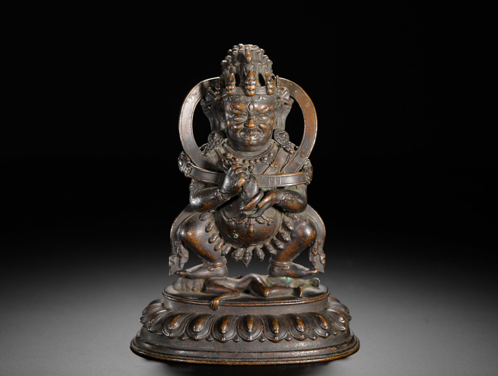 QING DYNASTY COPPER ALLOY TWO-ARMED GREAT BLACK SKY FIGURE: H:14.8cm(5.83in)W:10.6cm(4.17in)Weight:730g(1.61lb)Mahakala is one of the most important protector deities in Tibetan Buddhism, revered for safeguarding the Dharma and removing adversity