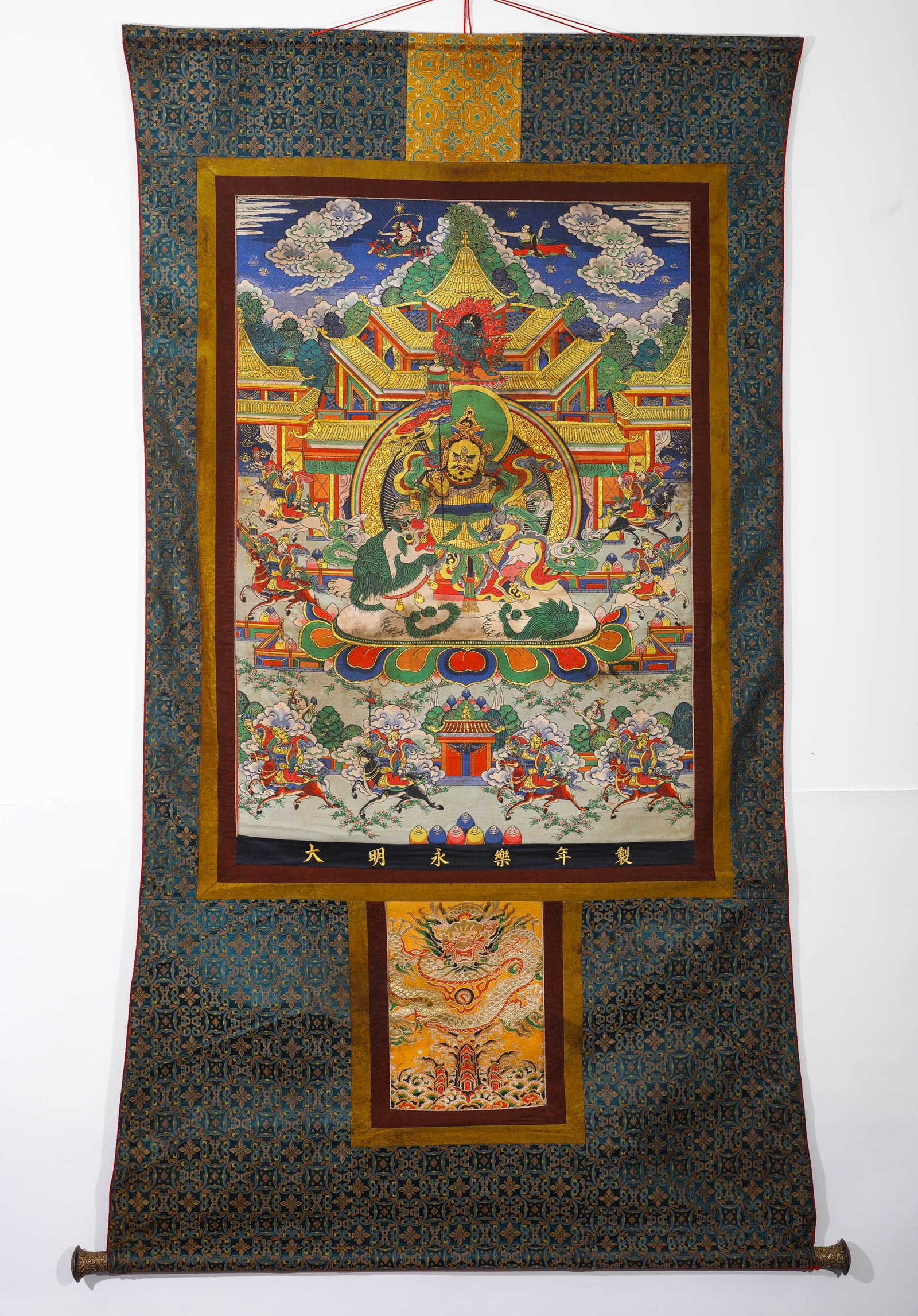 A THANGKA OF THE GREAT MING YONGLE STYLE OF THE GREAT HEARING OF THE HEAVENLY KING: H:185CMW:97CMTIBETAN BUDDHIST PAINTED THANGKA, FULLY MOUNTED AS VERTICAL HANGING SCROLL, INSCRIBED WITH "MADE IN YONGLE REIGN OF GREAT MING" ALONG THE BOTTOM BORDER