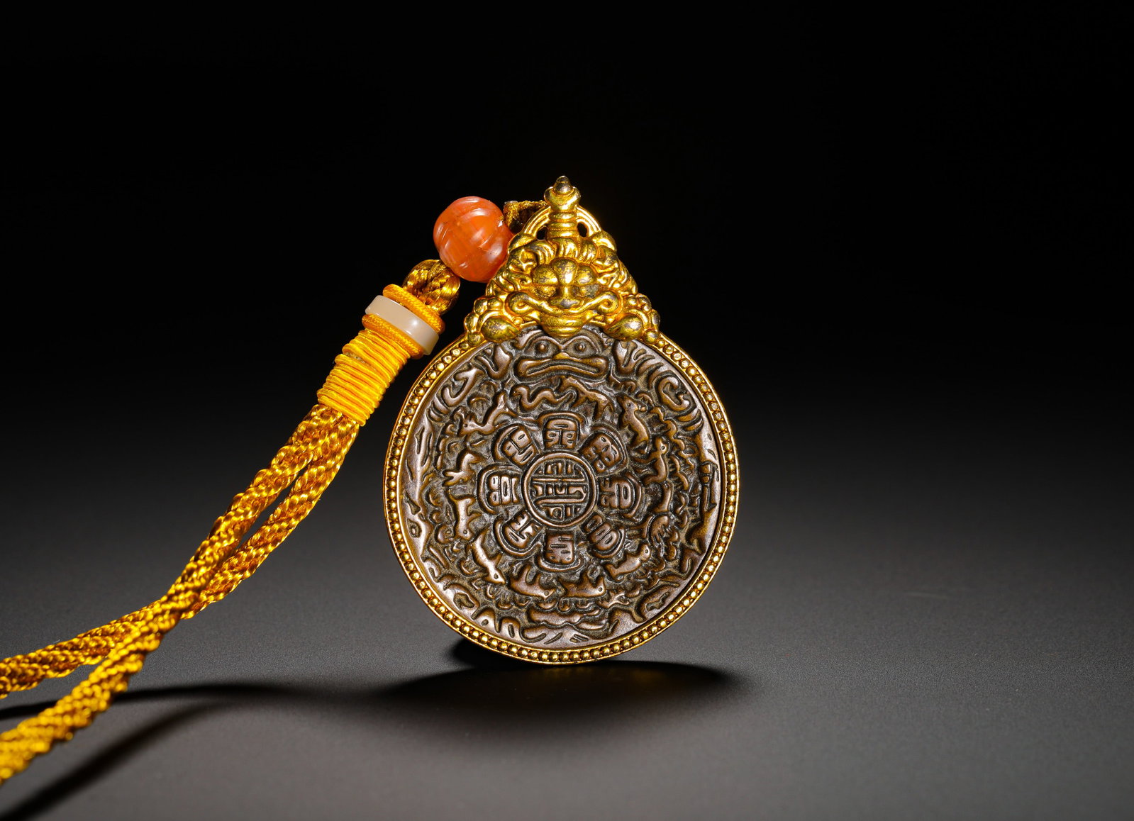 BRONZE GILDED NINE PALACES AND EIGHT TRIGRAMS OF THE QING DYNASTY: HEIGHT:6.8CM (2.68IN) WIDTH:5CM (1.97IN) WEIGHT:44G (0.10LB) QING TIBETAN NINE-PALACE ZODIAC AMULET WITH GILDED COPPER FRAME. THE TOP IS DECORATED WITH A TAOTIE BEAST HEAD CLASP; THE OBVERSE BEARS DEE