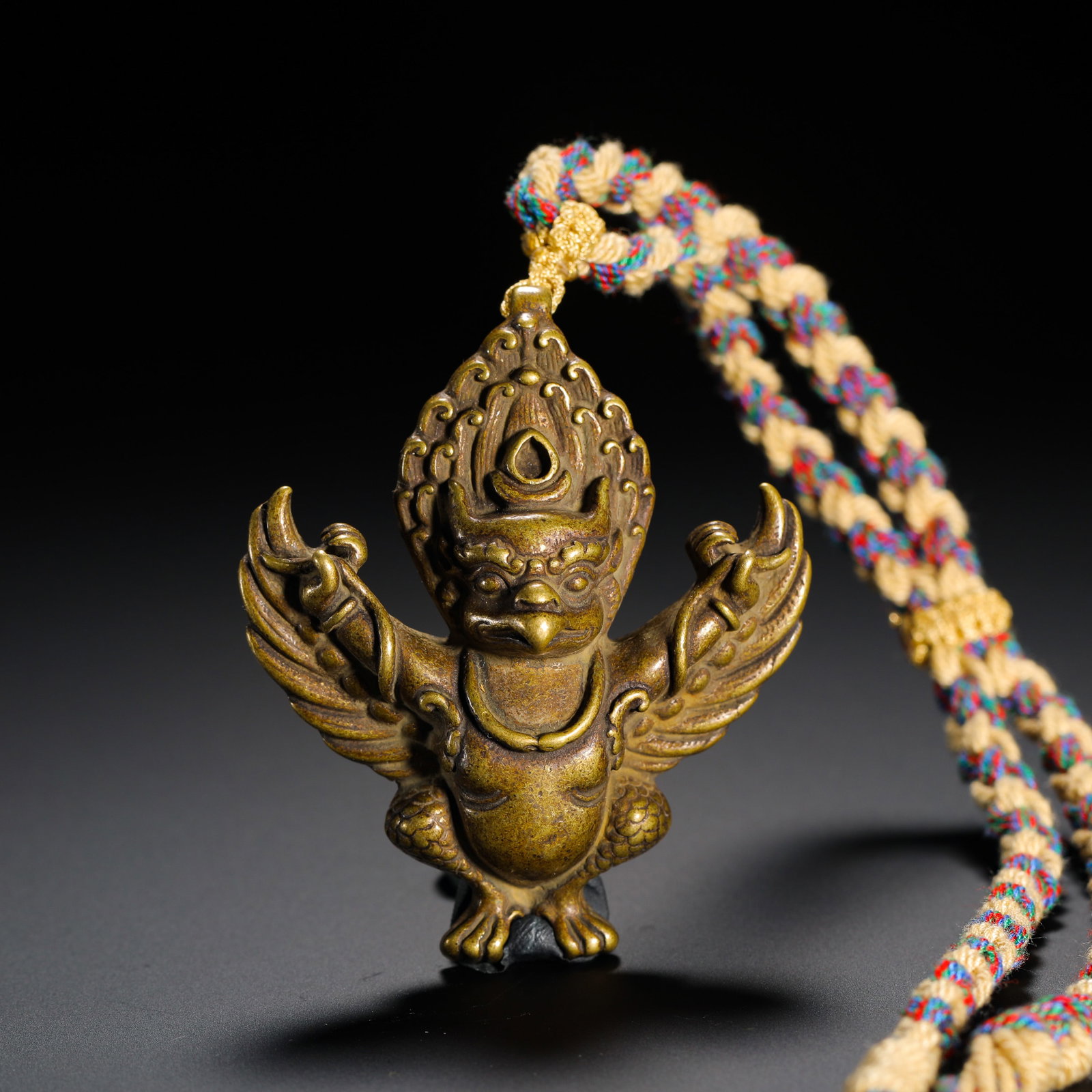 QING DYNASTY COPPER GOLDEN-WINGED GREAT PENG BIRD PENDANT FOR PROTECTOR: HEIGHT:5.8CM (2.28IN) WIDTH:5CM (1.97IN) WEIGHT:37G (0.08LB) ANTIQUE COPPER PENDANT OF GARUDA (GOLDEN-WINGED GREAT BIRD) , QING TIBETAN BUDDHISM. FULLY CAST IN ONE PIECE, IT FEATURES BEAST-FACED AVIAN