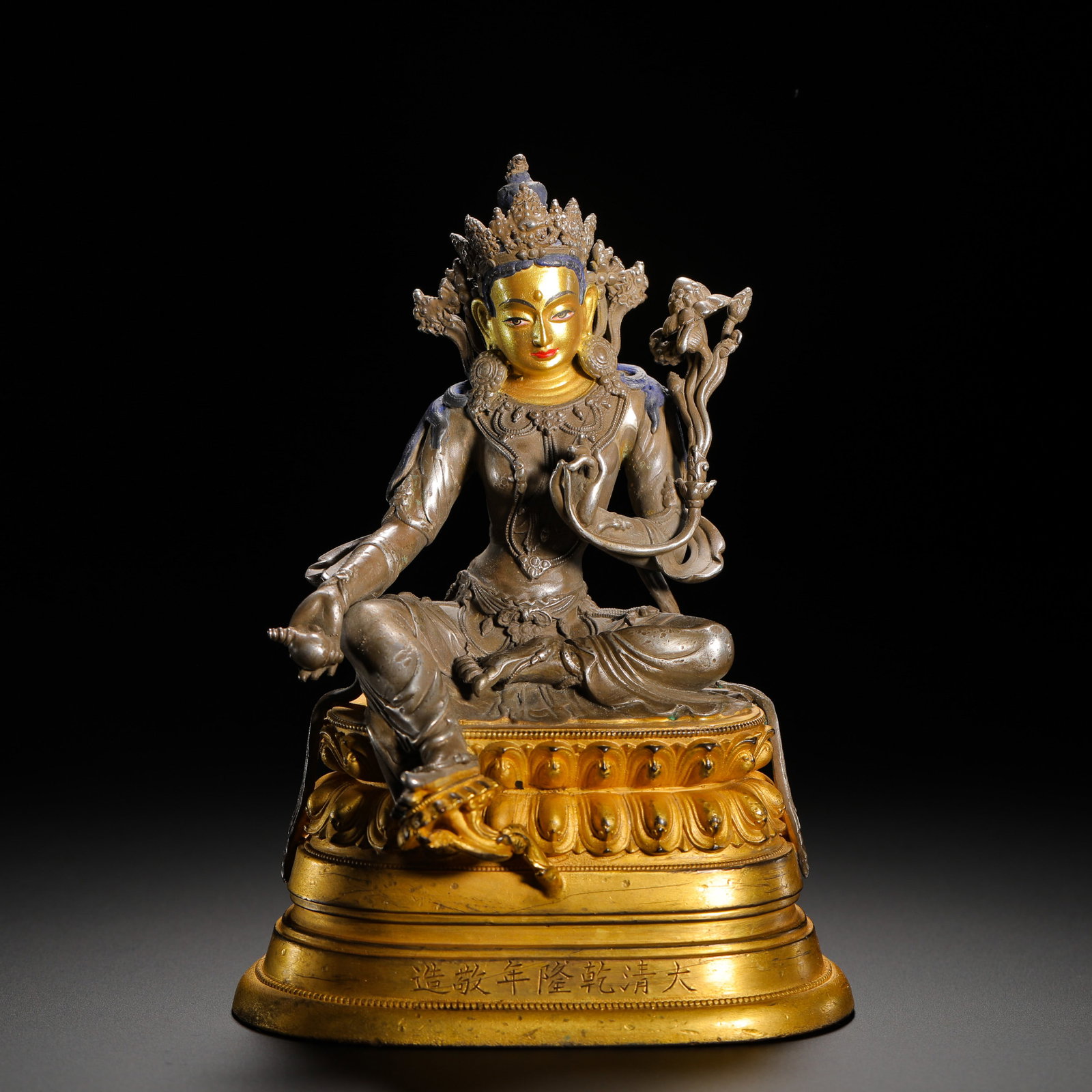 A GILT-BRONZE STATUE OF THE FREE AND EASY GUANYIN IN THE QIANLONG PERIOD OF THE QING DYNASTY: HEIGHT:13.5CM (5.31IN) WIDTH:10.5CM (4.13IN) WEIGHT:660G (1.45LB) IMPERIAL STATUE OF AVALOKITESHVARA, QIANLONG REIGN OF QING DYNASTY. THE LOTUS BASE IS FULLY GILDED COPPER WHILE THE BODHISATTVA BODY I