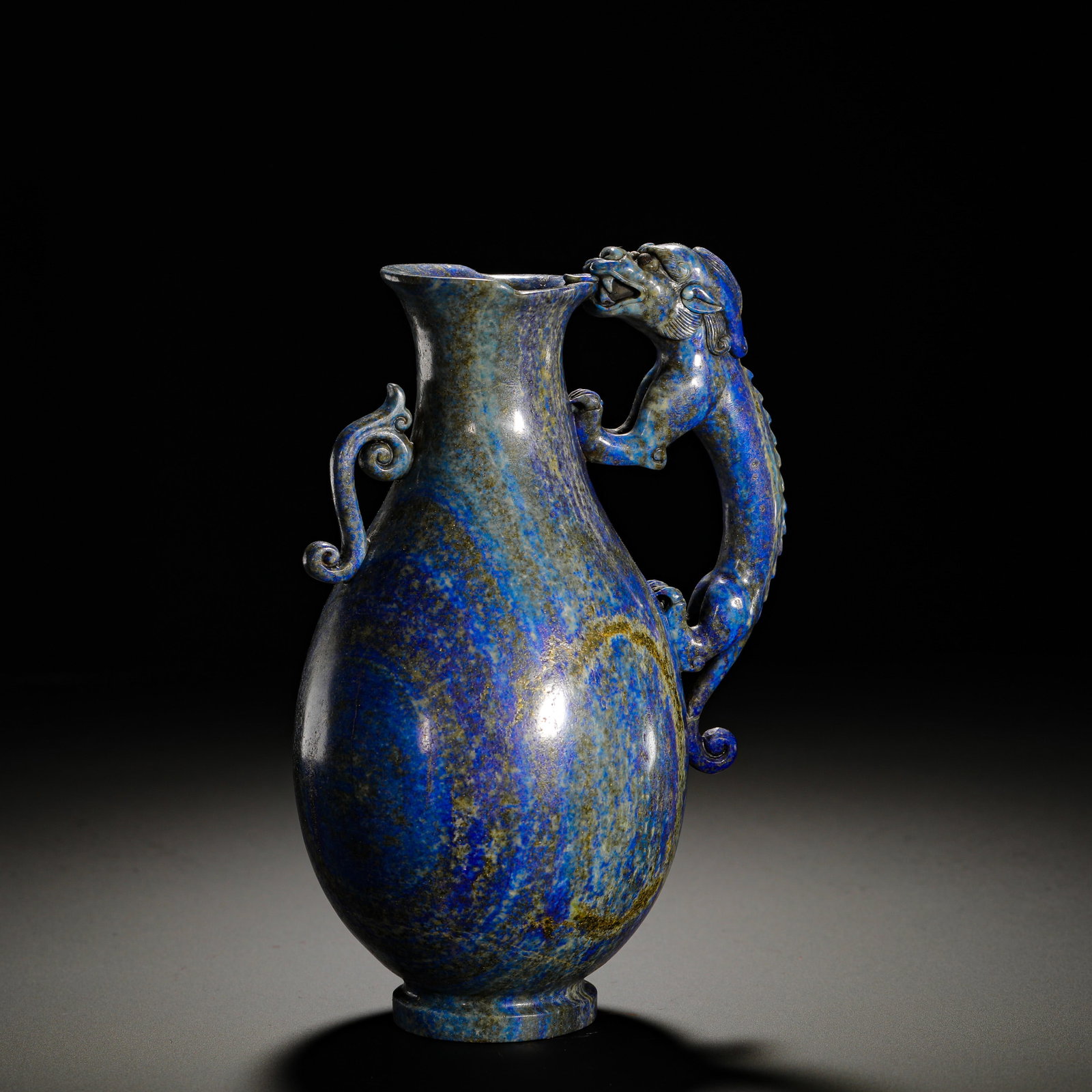 QING DYNASTY LAPIS LAZULI CHILONG TEAPOT: HEIGHT:18.5CM (7.28IN) WIDTH:13CM (5.12IN) WEIGHT:2250G (4.96LB) SOLID LAPIS LAZULI WINE EWER, QING DYNASTY, CARVED FROM A SINGLE NATURAL LAPIS BLOCK WITH RICH BLUE BASE MIXED WITH GOLDEN PYRITE SPOTS