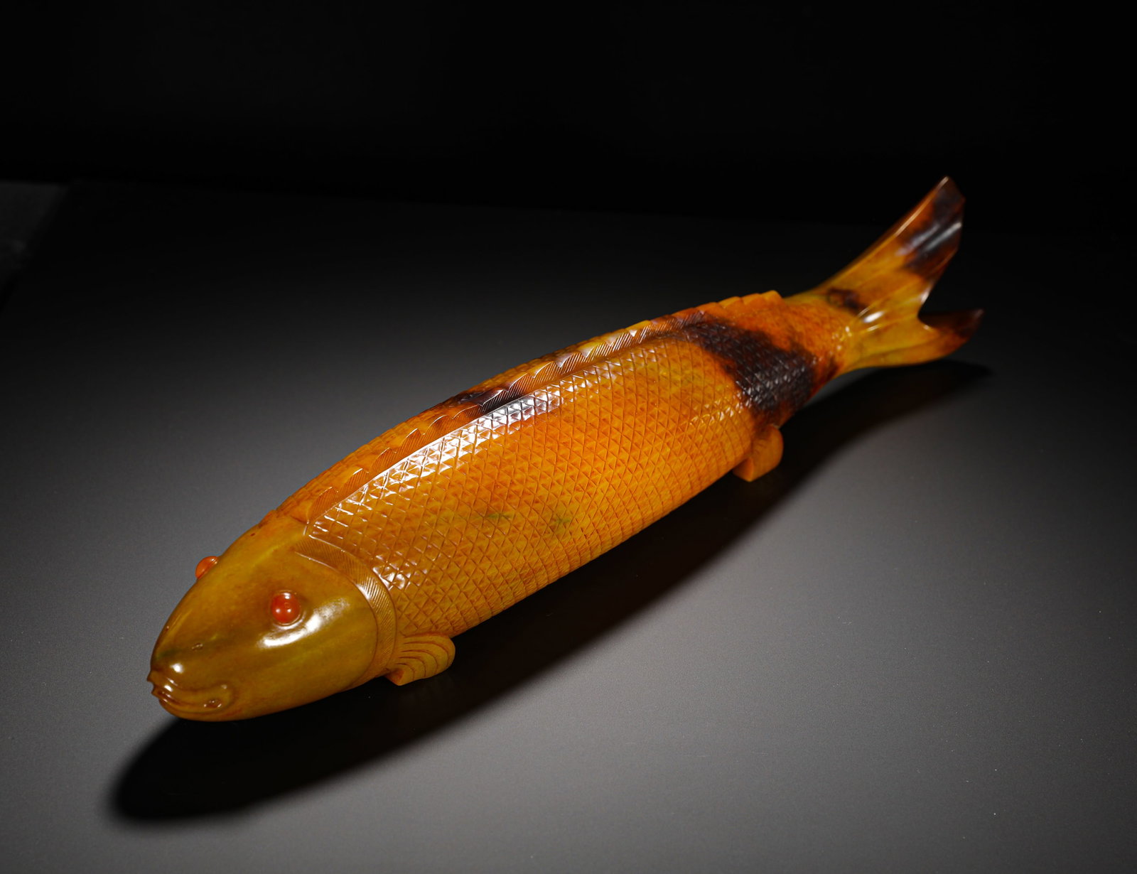 A REALISTIC LARGE CARP FIGURINE FROM HUANGQIN HETIAN JADE OF THE QING DYNASTY: L: 48CM WEIGHT: 4680G