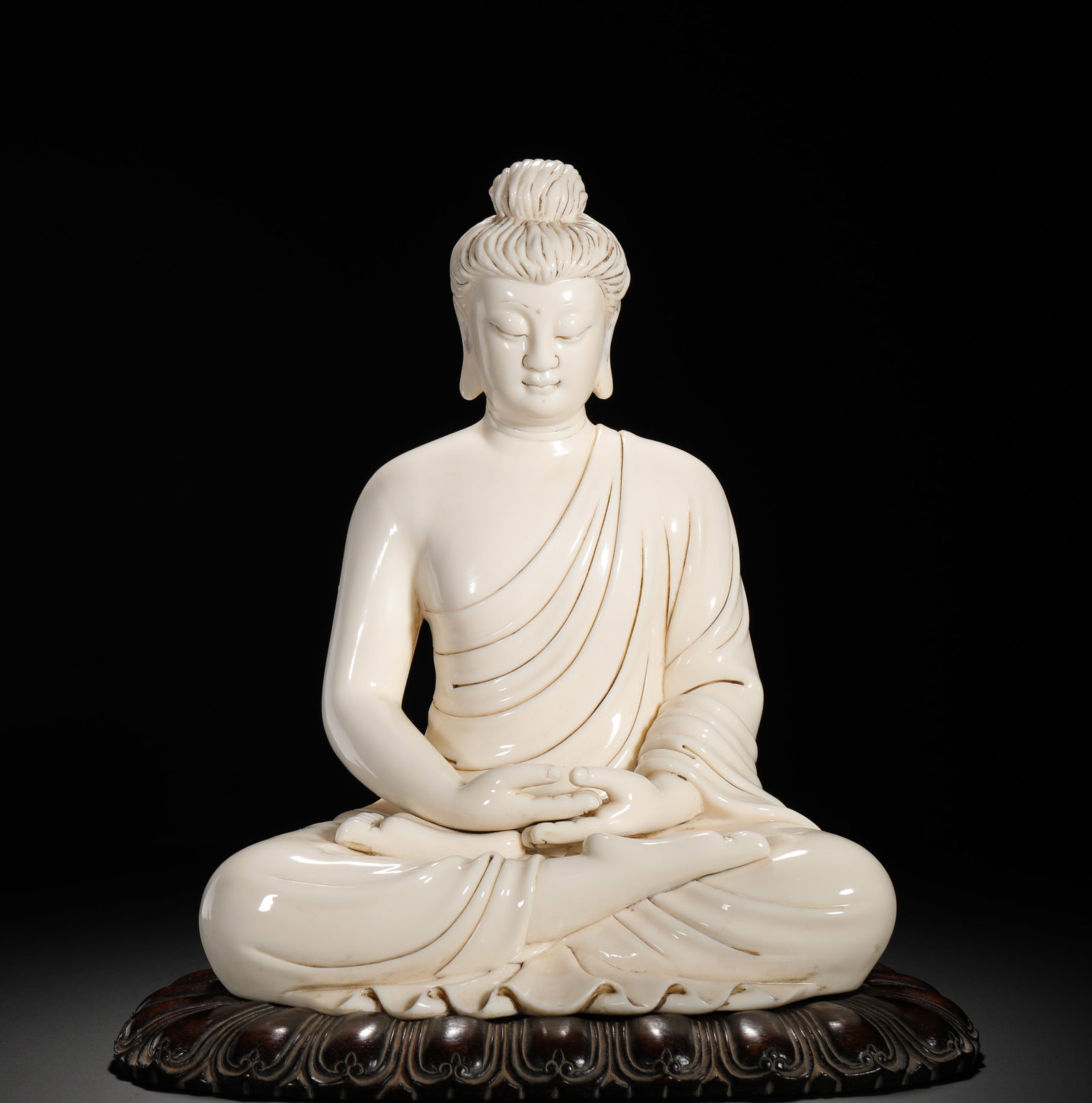 A SITTING BUDDHA OF SAKYAMUNI INSCRIBED BY HE CHAOZONG OF THE DEHUA KILN OF THE QING DYNASTY (1 of 10)
