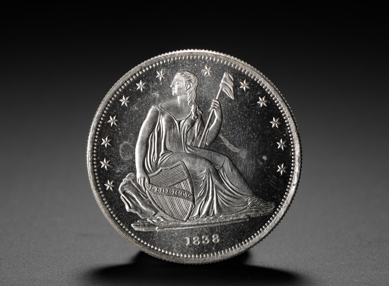 AMERICAN SILVER COIN: D:3.9CM (1.54IN) WEIGHT:27G (0.06LB) A CLASSIC CIRCULATING SILVER COIN ISSUED IN MID-19TH CENTURY AMERICA, FEATURING THE SEATED LIBERTY DESIGN ON THE OBVERSE, A REPRESENTATIVE TYPE OF THE "SEATED LIBE