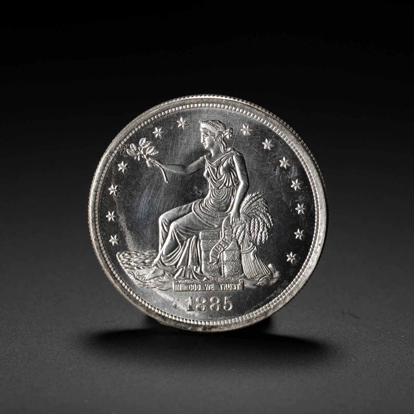 AMERICAN SILVER DOLLAR: D:3.9CM (1.54IN) WEIGHT:27G (0.06LB) A SILVER COIN ISSUED BY THE UNITED STATES SPECIFICALLY FOR EAST ASIAN TRADE MARKETS. THE 1885 ISSUE IS THE FINAL YEAR OF THE TRADE DOLLAR SERIES, WITH EXTREMELY LO