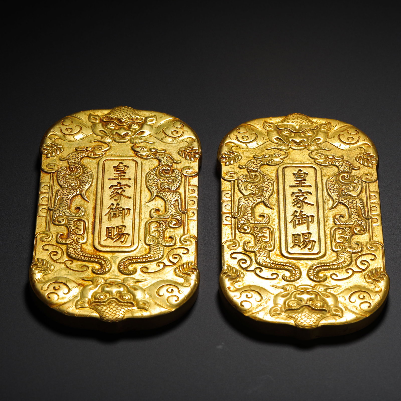 A PAIR OF GILDED BRONZE TOKENS BESTOWED BY IMPERIAL DECREE OF THE IMPERIAL TREASURY OF CHENGDE: HEIGHT:9.5CM (3.74IN) WIDTH:5.8CM (2.28IN) WEIGHT:630G (1.39LB) PAIR OF BRONZE-GILDED SUMMER RESORT WAREHOUSE OFFICIAL TOKENS, KANGXI REIGN OF QING DYNASTY, MANUFACTURED BY IMPERIAL HOUSEHOLD DEPARTME