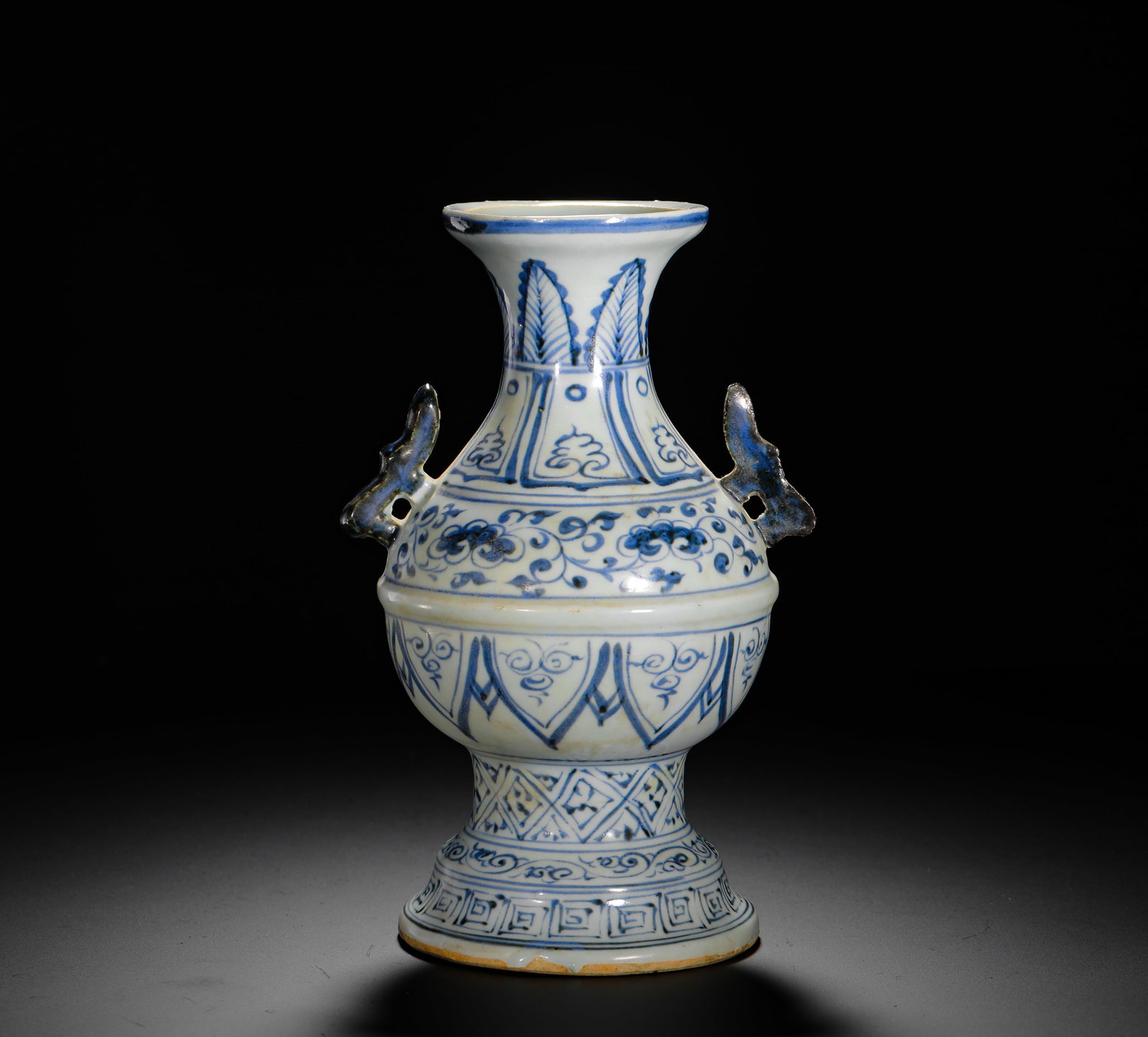 EARLY MING DYNASTY BLUE AND WHITE DOUBLE-EARED VASE WITH FLORAL PATTERNS: H:21CM (8.27IN) W:14CM (5.51IN) WEIGHT:810G (1.78LB) THIS IS A MING DYNASTY PORCELAIN VASE FROM THE JINGDEZHEN KILN. WITH AN ELEGANT FORM, IT IS DECORATED WITH MULTIPLE LAYERS OF FLORAL SCROLLS IN STA