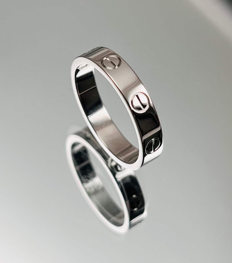 CARTIER LOVE COLLECTION 18K WHITE GOLD RING: Name Cartier LOVE Collection 18K White Gold Ring Dimensions Forged from premium 18K white gold, the band is adorned with the brand's signature screw motifs for instant recognizability. Its well-propor