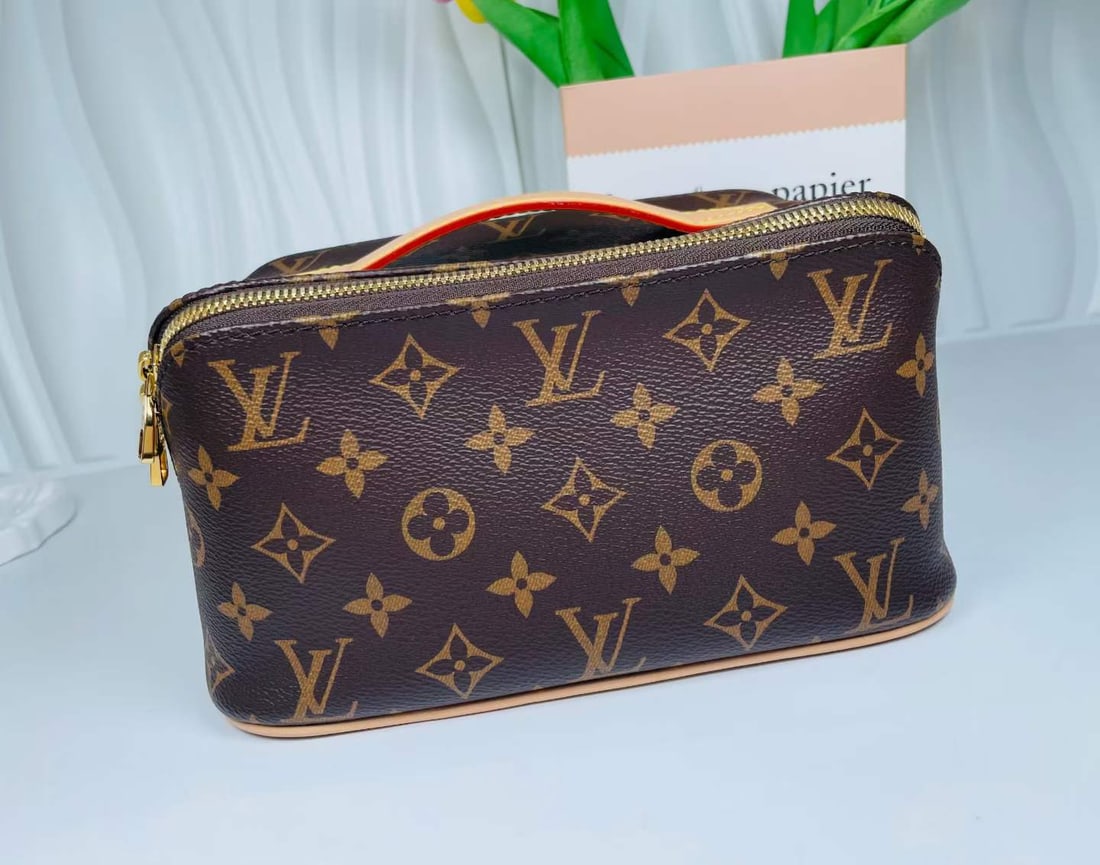 LOUIS VUITTON MONOGRAM TOILETRY POUCH: Name Louis Vuitton Monogram Toiletry Pouch Dimensions Made of classic monogram coated canvas with vegetable-tanned leather handles, it features dual metal zippers for closure. Spacious layered