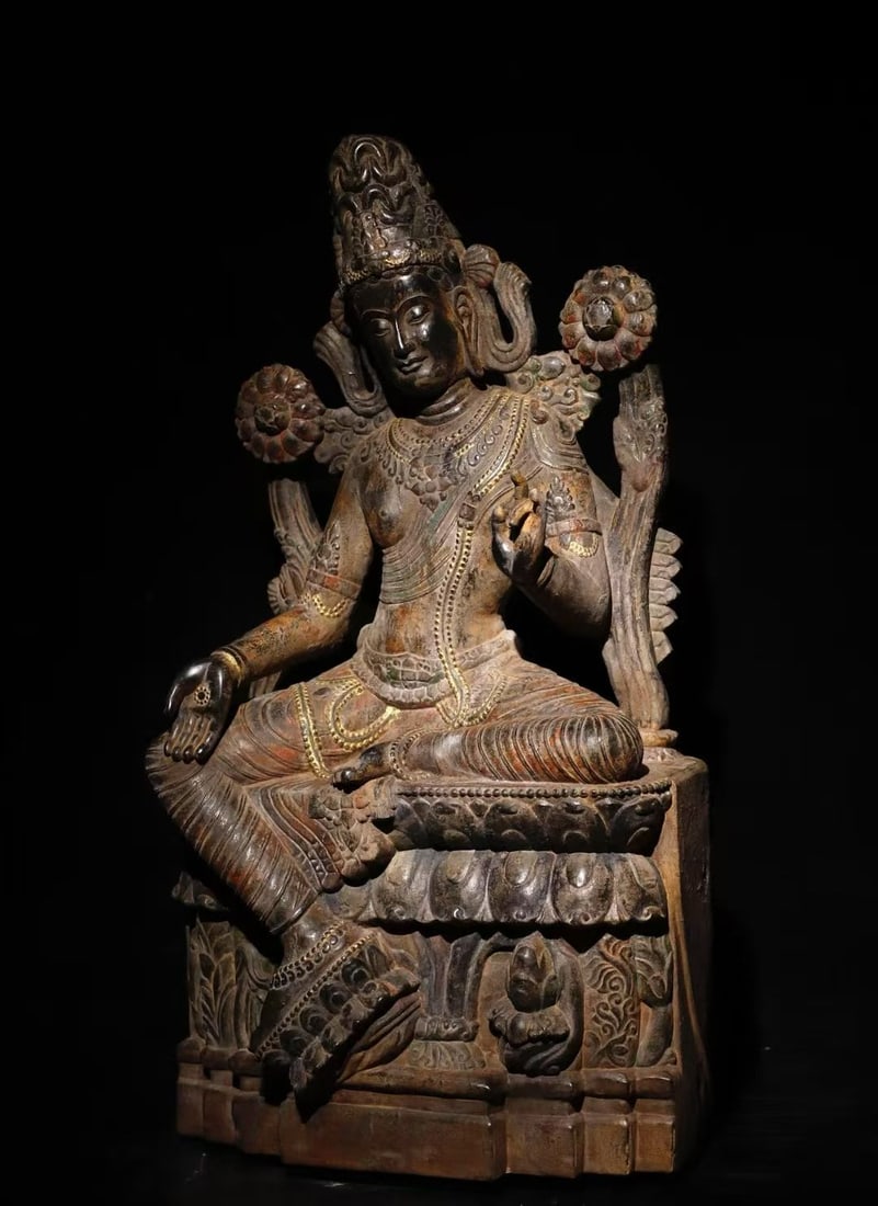 12TH-CENTURY PAINTED GUANYIN ON BLUESTONE: H:100cm (39.37in)W:58cm (22.83in)T:35cm (13.78in)Weight:250000g This is a stone statue of Avalokiteshvara (or Tara) in royal ease posture, dating from the 8th to 12th century in South Asian style.