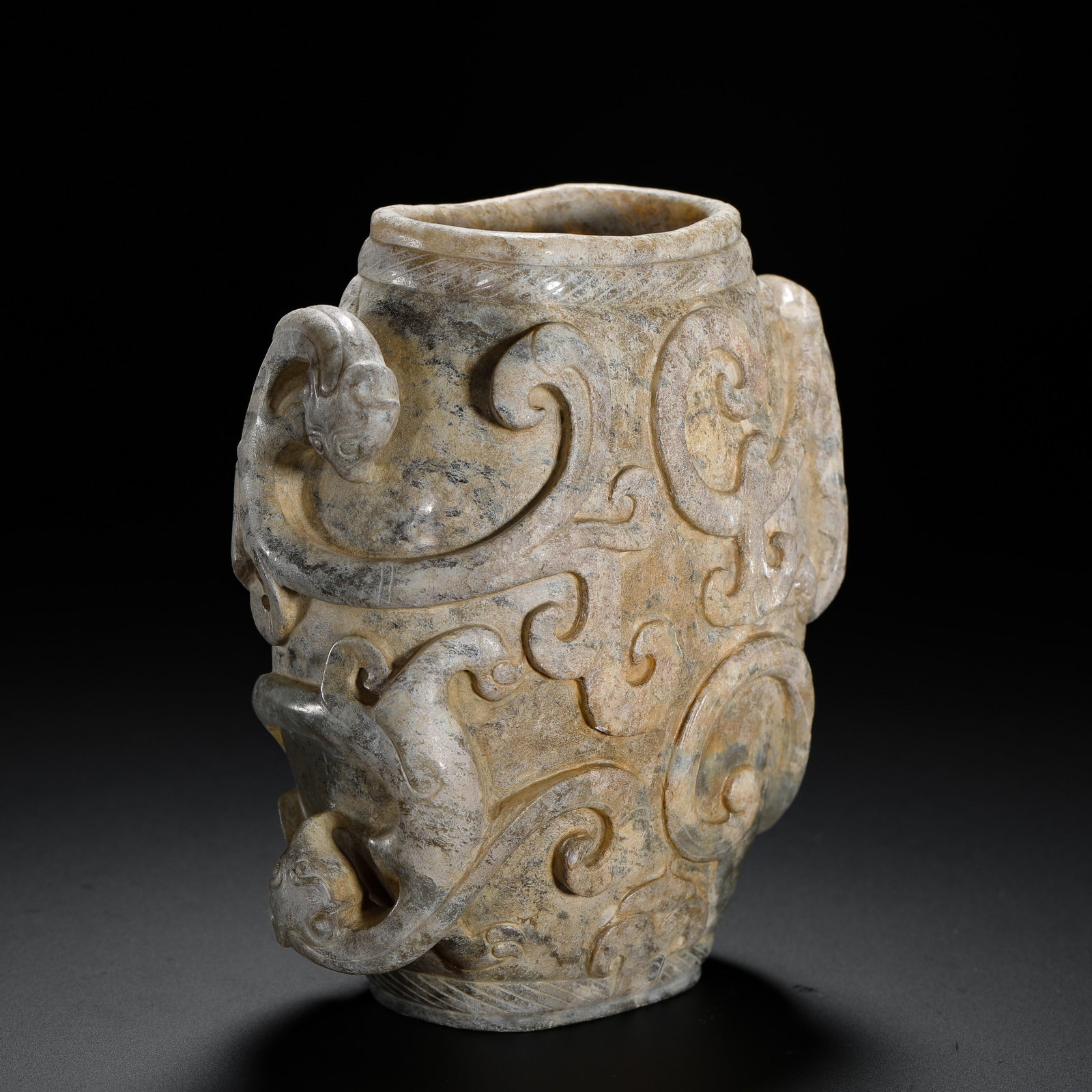 HAN DYNASTY HETIAN JADE CHILONG-PATTERNED CUPS: H:10cm W:8.5cm Weight:360g A Han Dynasty jade jar fully carved with chi dragons, covered in natural patina, an important ancient jade ornament.