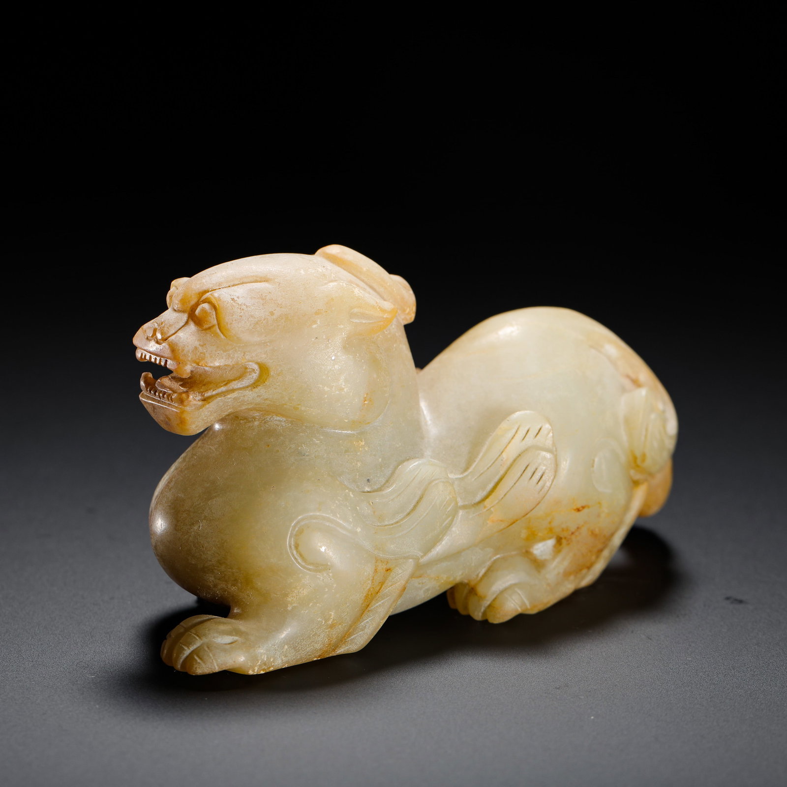 HAN DYNASTY HETIAN JADE RECLINING BEAST: H:5.5cm W:9.7cm Weight:240g A Han Dynasty round-carved jade beast with natural patina, simply shaped, used to ward off evil and attract fortune.??????????????????????????ô????????????????????????????