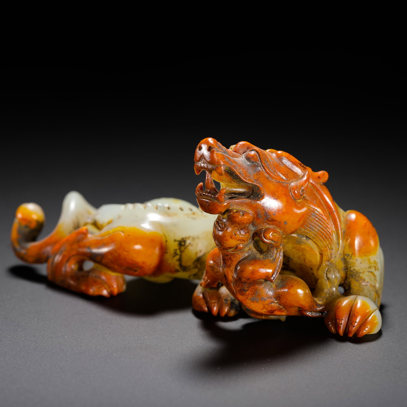 HAN DYNASTY HETIAN JADE RED IMPREGNATED MOTHER AND CHILD: H:6cm W:10.8cm Weight:130g Han Dynasty jade ornament of mother and cub chi dragons with striking red patina, symbolizing prosperous descendants and auspicious protection