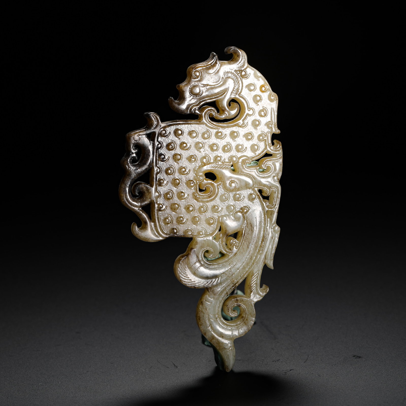 HETIAN JADE PENDANTS WITH DRAGON AND PHOENIX GRAIN PATTERNS FROM THE WARRING STATES PERIOD: H:10.6cm W:5.3cm Weight:50g A Warring States jade pendant fully decorated with grain patterns, openwork carved dragon and phoenix, symbolizing auspicious harmony, worn by nobles