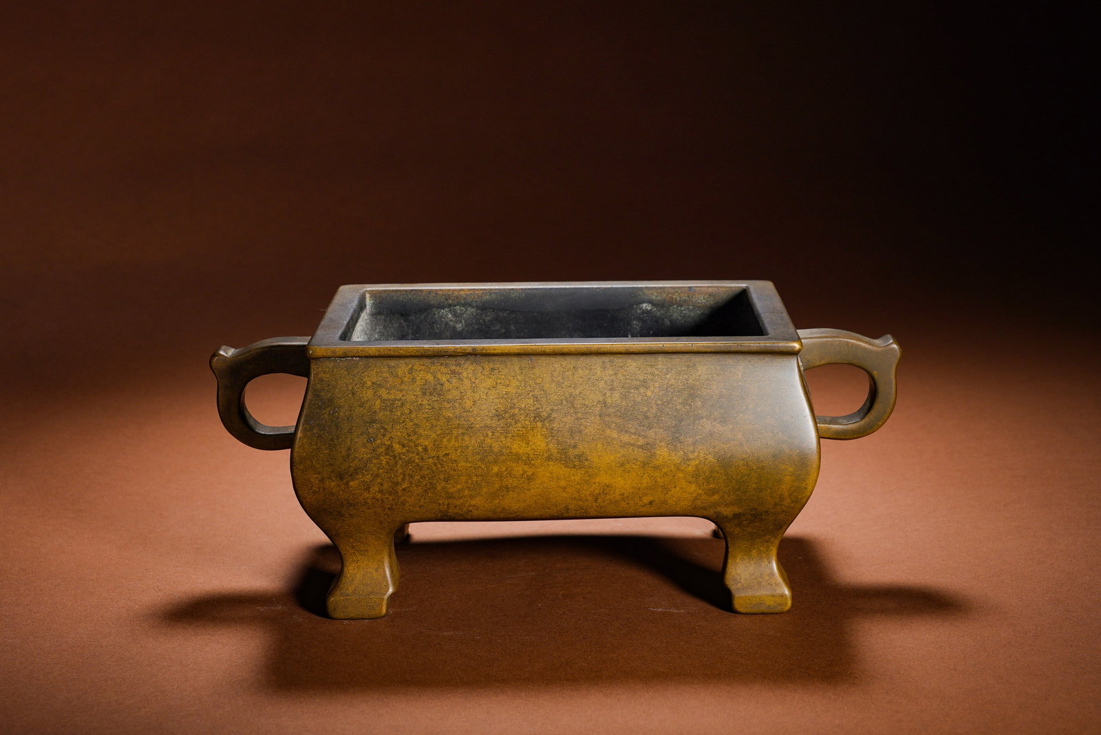 THE IMPERIAL XUANDE FURNACE OF THE QING DYNASTY: Height:10cm Width:24cm Weight:3310gCommonly named Horse Trough Censer, it is a classic sacrificial bronze for study display in Ming and Qing dynasties. Square and grand in shape with heavy solid coppe