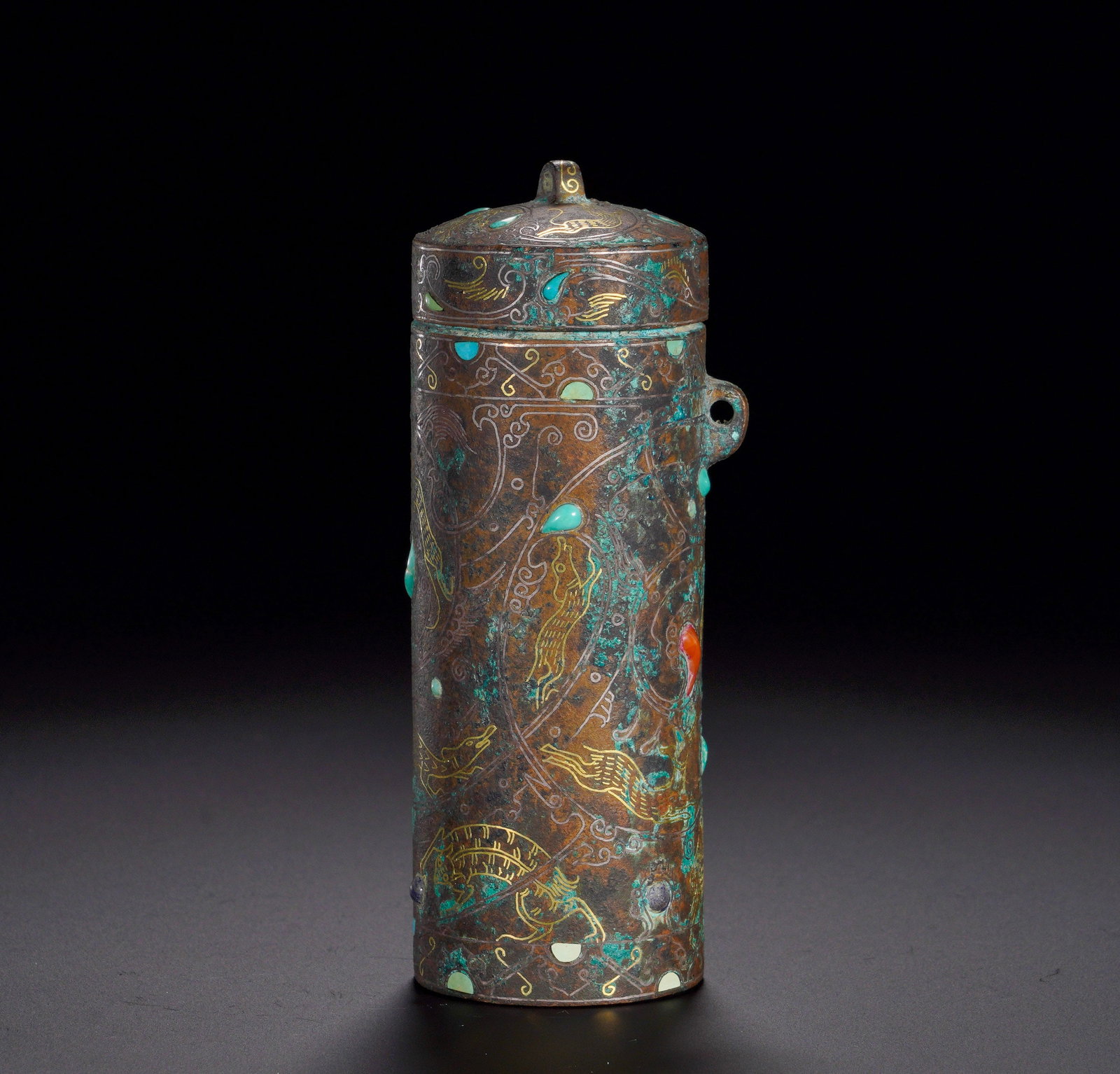 HAN DYNASTY BRONZE INLAID WITH GOLD AND SILVER INLAID WITH AUSPICIOUS BEAST PATTERN TUBE: Height:10.5cm (4.13in)Width:5cm (1.97in)Weight:220g(0.48lb)Straight cylindrical body with side loop for cord, topped with lidded knob. The surface is decorated with immortal beasts and cloud scrolls i