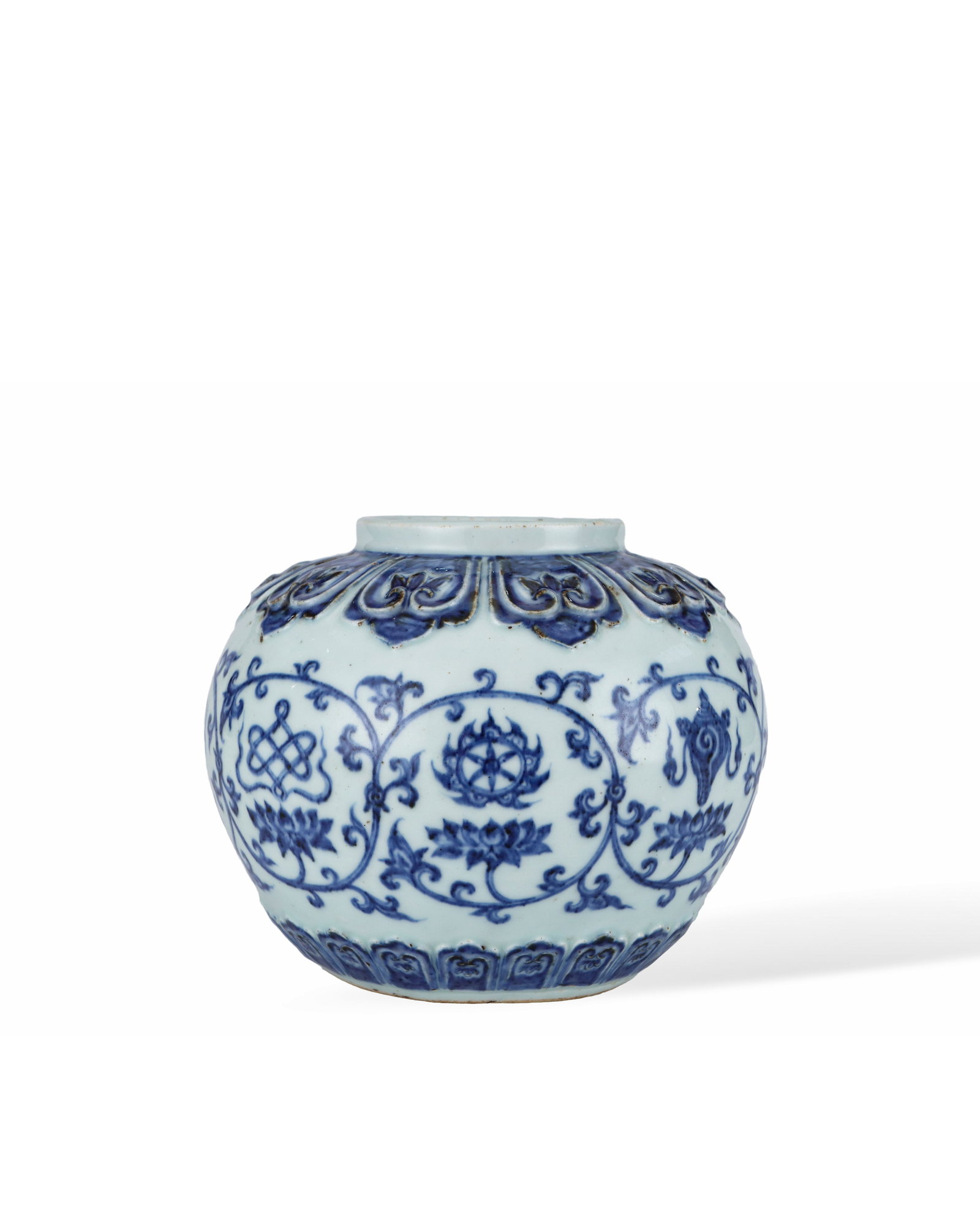 MING XUANDE BLUE AND WHITE LOTUS WITH EIGHT TREASURES PATTERN JAR: H:15.2cm W:18.8cm This is an official blue-and-white storage jar of Ming or Qing Dynasty, shaped like a drum with short straight mouth and plump round belly. It is covered with pale bluish white glaze
