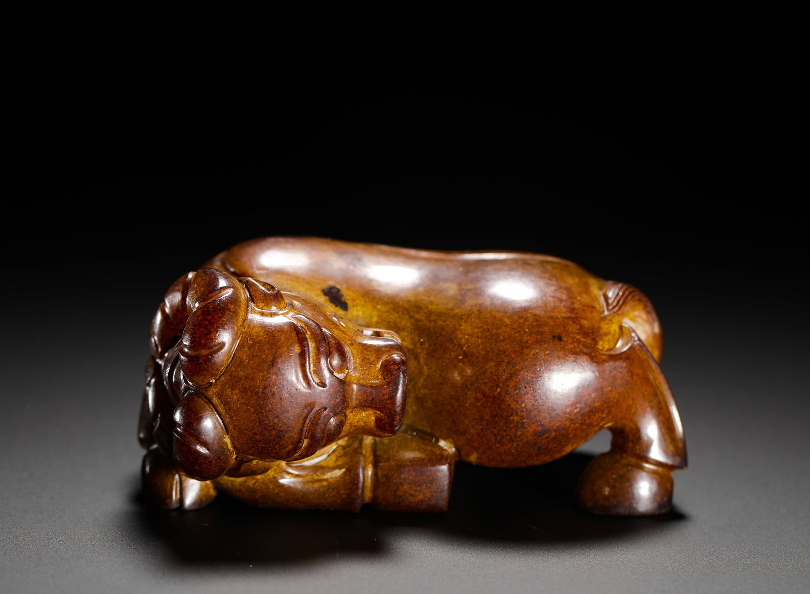 HAN DYNASTY HETIAN JADE RECLINING OX: Height:4cm (1.57in) Width:8cm (3.15in) Weight:272g(0.60lb)Antique solid jade hand-carved recumbent ox ornament. The ox crouches with coiled horns, full muscular body, smooth mellow antique brown patin