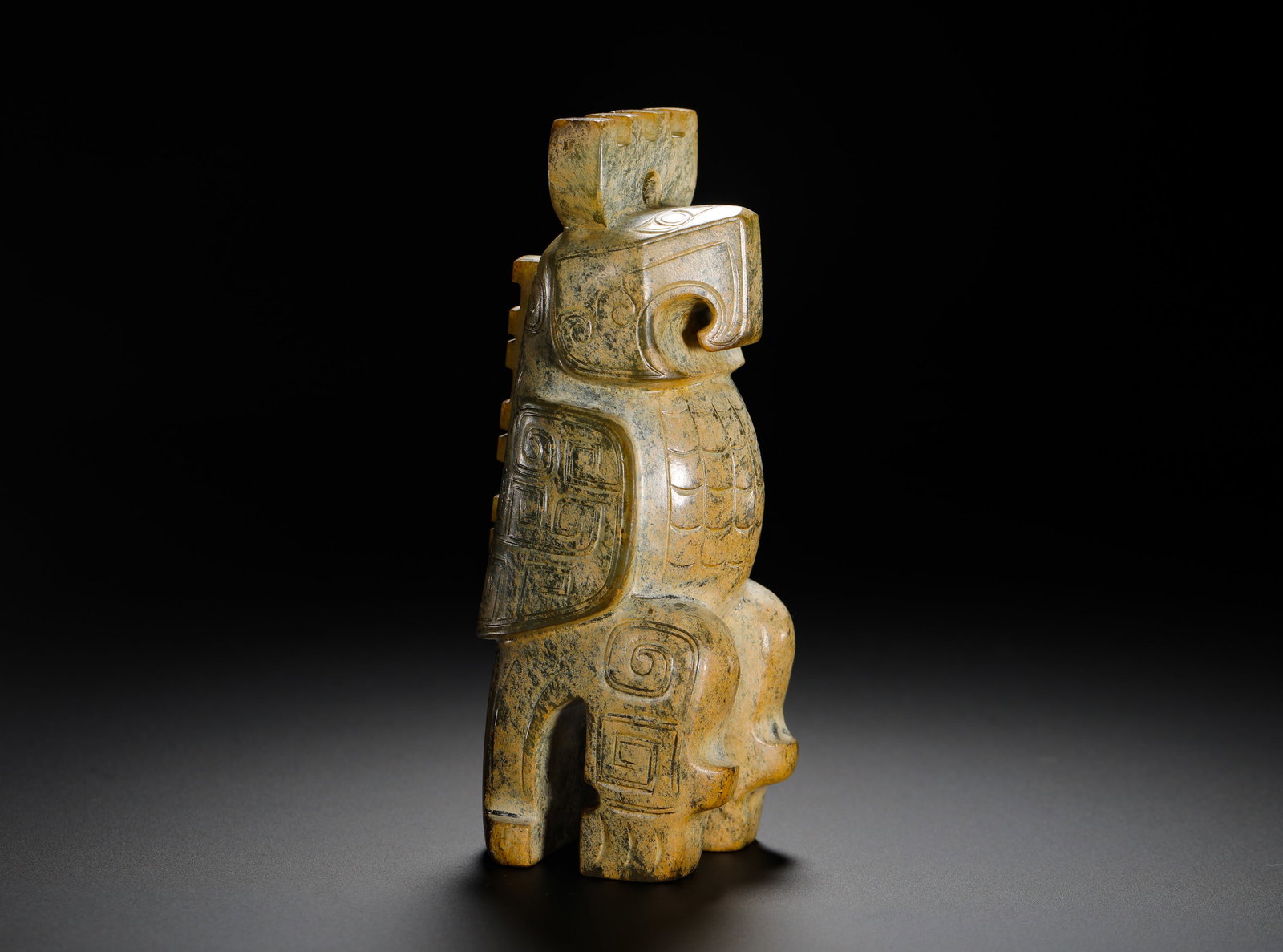 SHANG DYNASTY JADE OWL RITUAL VESSEL: Height:11.5cm (4.53in) Width:4.5cm (1.77in) Weight:370g(0.82lb)Shang-Zhou carved jade owl totem ritual statue, integrated solid jade carving with perforated crown for shrine hanging. The sacred bird s