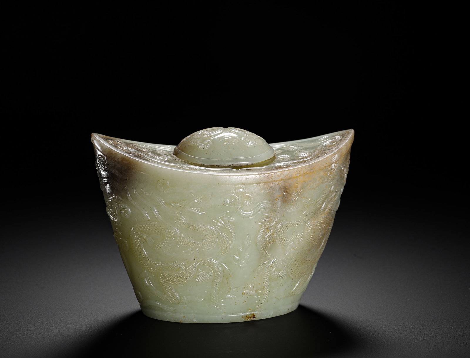QING DYNASTY HETIAN WHITE JADE DOUBLE DRAGON INGOT SHAPED LID BOX: Height:8.5cm (3.35in) Width:12cm (4.72in) Weight:460g(1.01lb)Qing Dynasty Hetian white jade ingot-shaped covered censer box carved with double dragon patterns. Single whole-jade carving with flower li