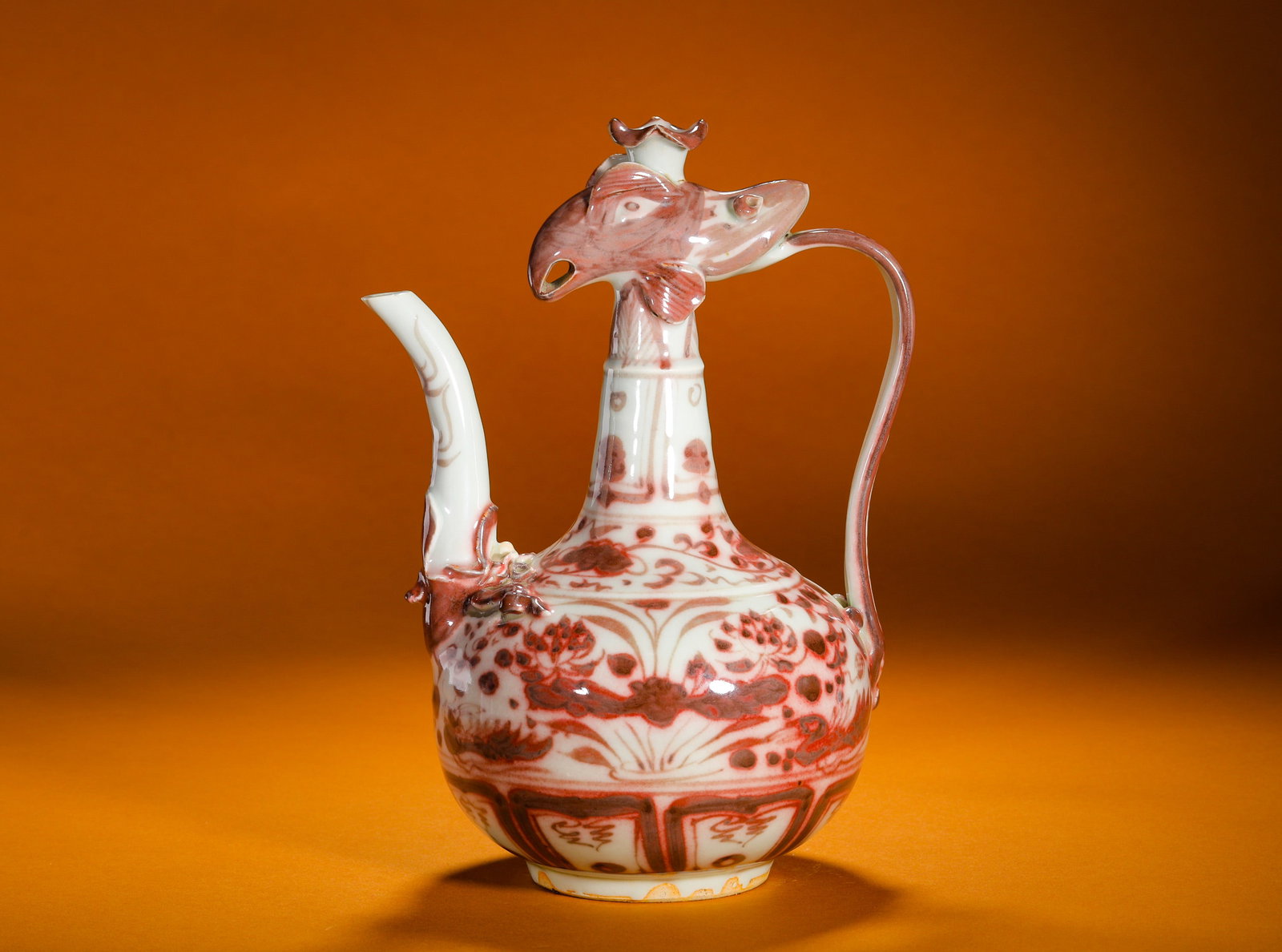 YUAN DYNASTY UNDERGLAZE RED PHOENIX-HEADED LOTUS POND PATTERN EWER: Height:24cm (9.45in)Width:17cm (6.69in)Weight:790g(1.74lb)Antiqueunderglazeredphoenix-headwineewer, lotusponddecoration, rareimperialcopper-redporcelain.