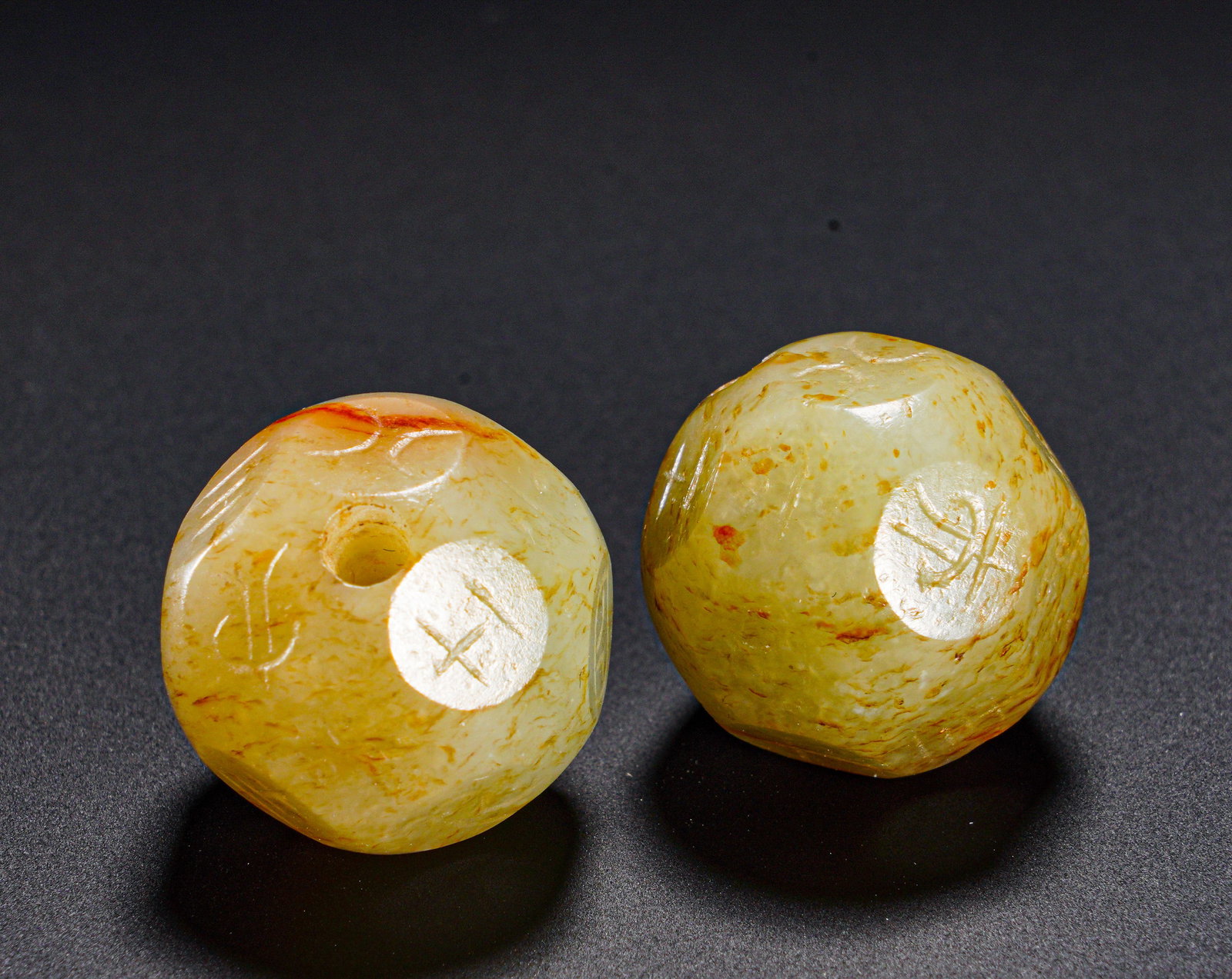 HAN DYNASTY HETIAN JADE DICE: Diameter:2cm (0.79in)Weight:20g(0.04lb)Ancient paired jade polygonal beads engraved with eight trigrams. The jade bears pale white base suffused with natural reddish-yellow aged patina. Each bead is c