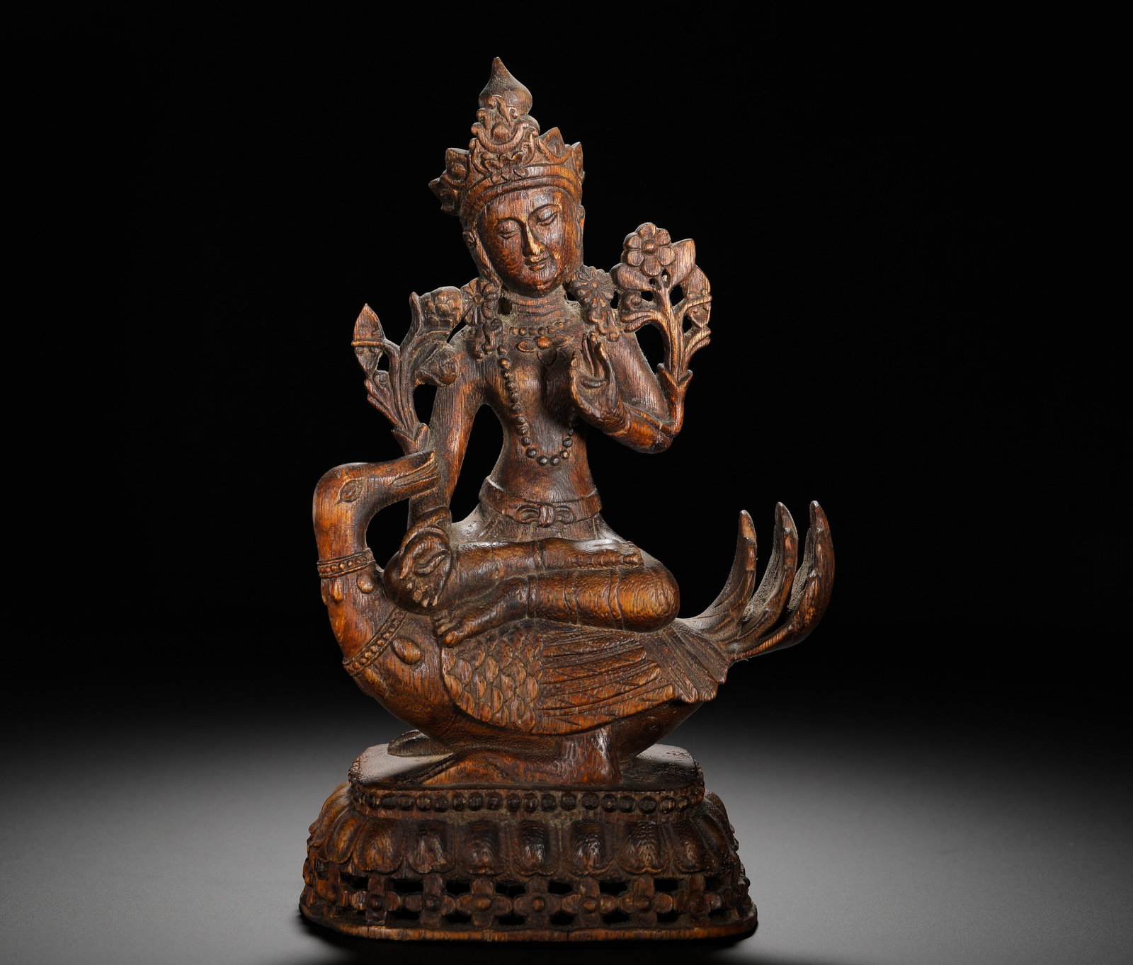 QING DYNASTY AGARWOOD STATUE OF TARA RIDING A PEACOCK: Height:21cm (8.27in) Width:13.5cm (5.31in) Weight:120g(0.26lb)Agarwood carved Tara statue seated on peacock, wearing crown, holding lotus flower, with openwork lotus pedestal, Tibetan Buddhist wood ca