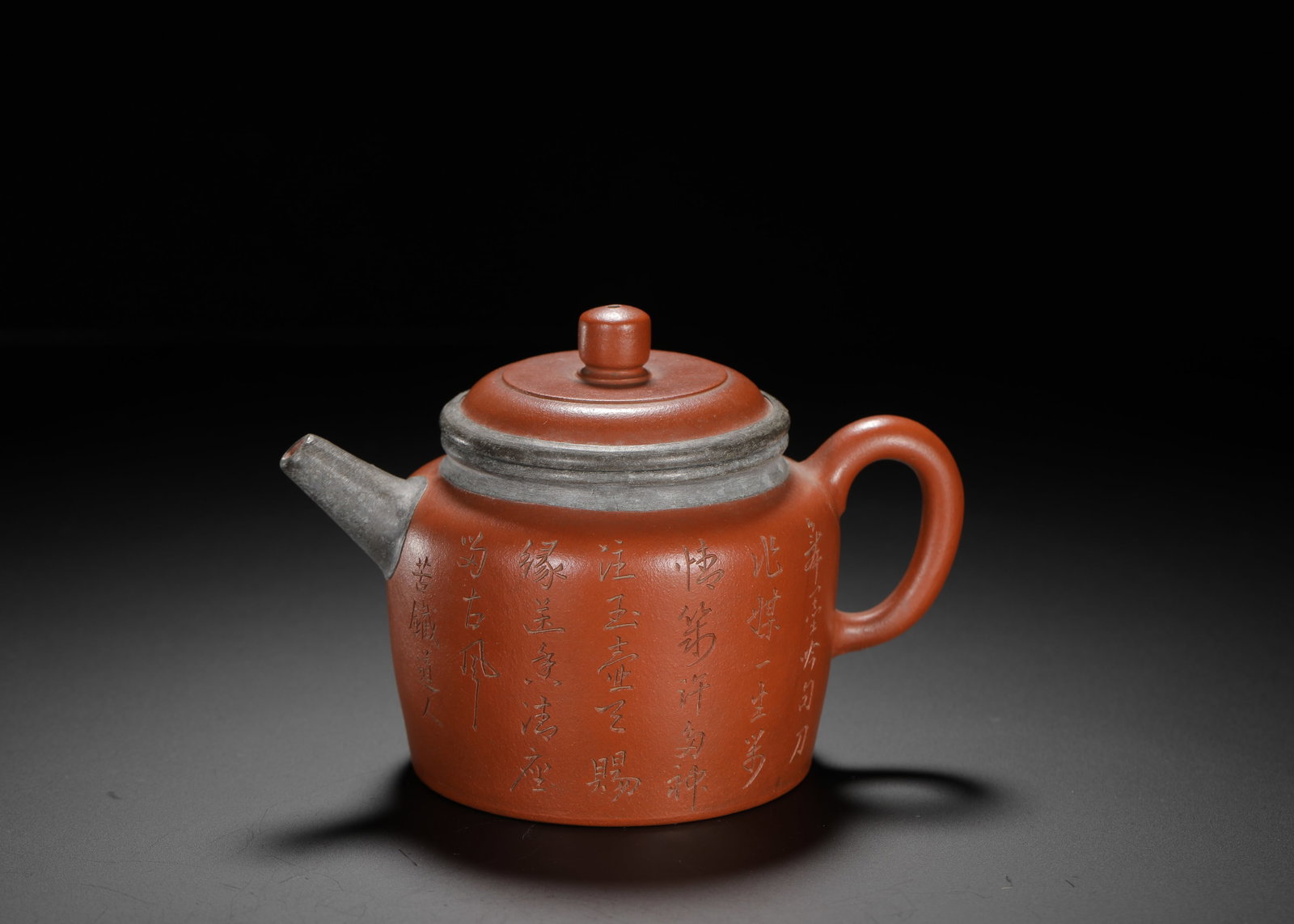 ZHU NI TIN WRAPPED STRAIGHT TUBE ORCHID ENGRAVED PURPLE CLAY TEAPOT: H:9cm W:13cm Weight:230g Mini straight Han-style teapot made of natural vermilion clay, with tin wrapping craft on lid rim and spout for antique unique texture. Elongated cylindrical body, neat spheri