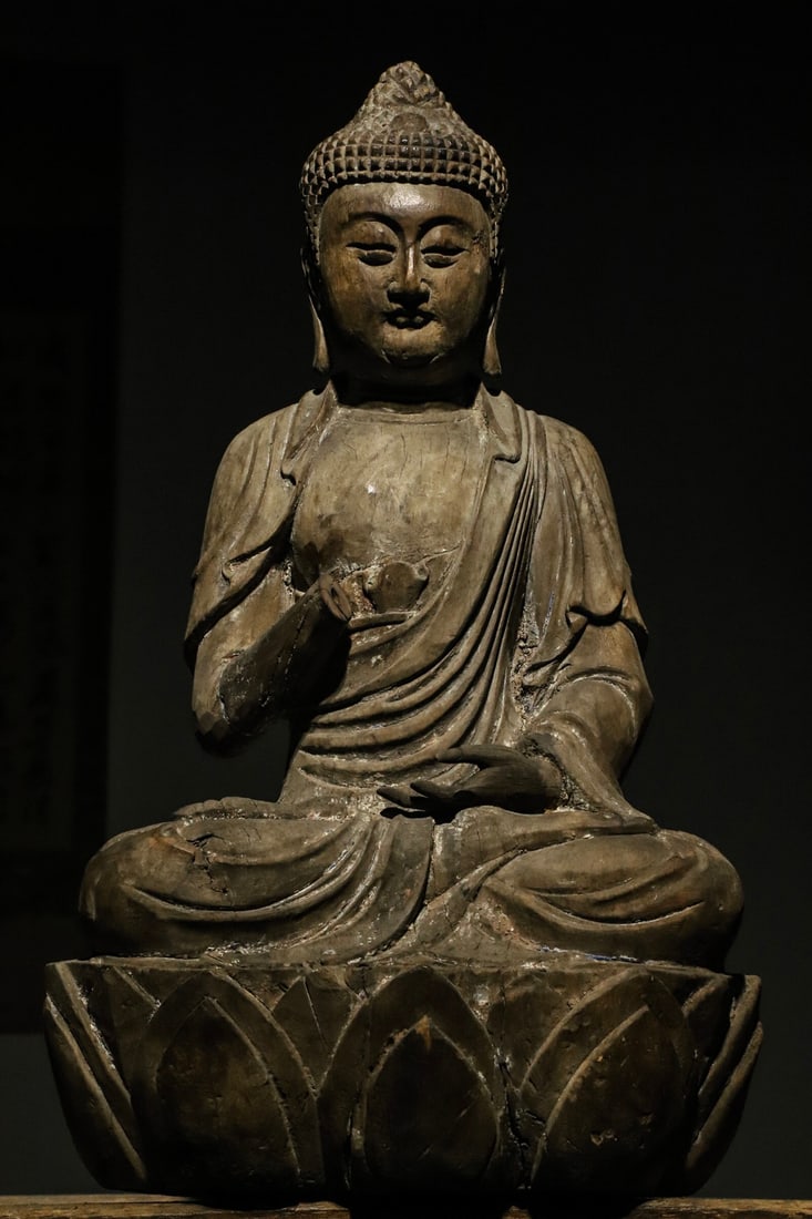 A SEATED STATUE OF SAKYAMUNI MADE OF NANMU WOOD FROM THE MING DYNASTY (1 of 9)