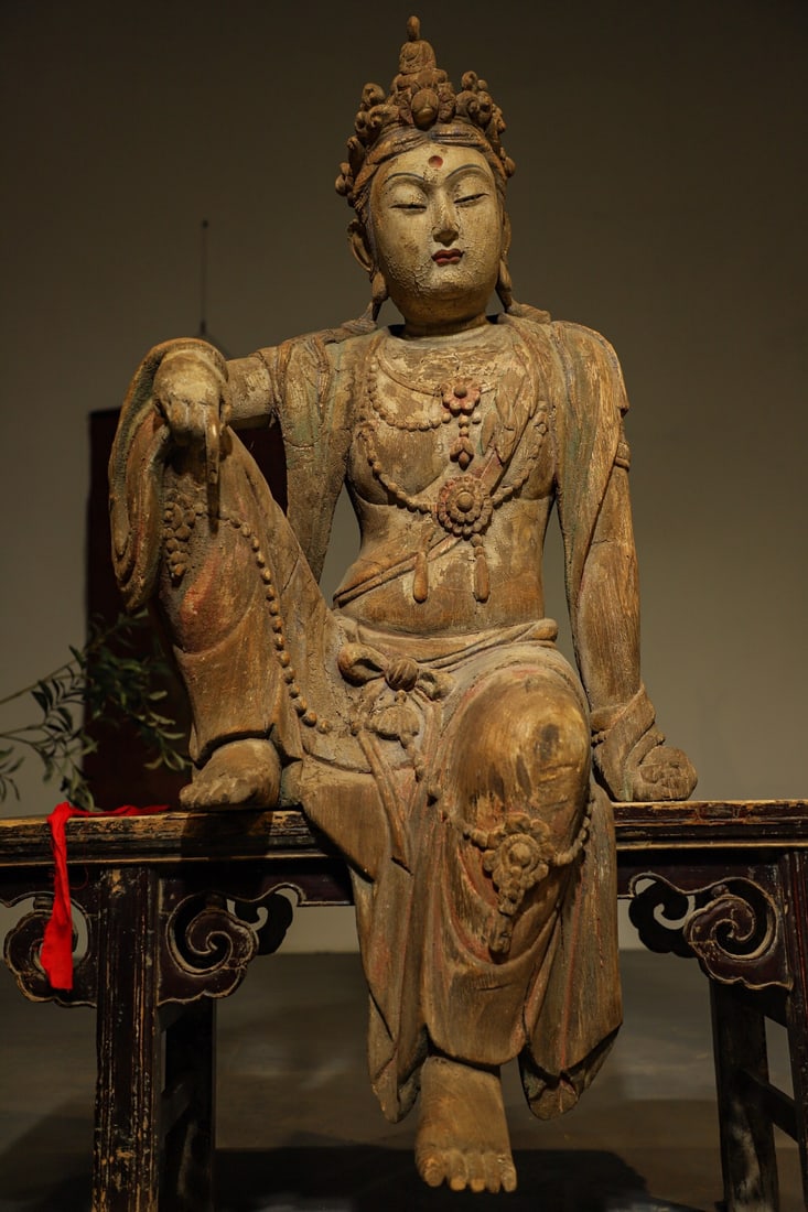 MING DYNASTY CAMPHOR WOOD GUANYIN BODHISATTVA: H:125cm L:66cm W:55cm The theme of "Water Moon Guanyin" originates from Buddhist scriptures, symbolizing that Buddhism is like the moon in water, being illusory and insubstantial. This type of statue 