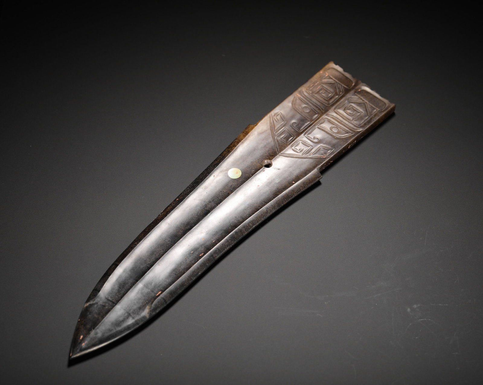 SHANG DYNASTY HETIAN JADE BEAST FACE PATTERN JADE HALBERD RITUAL VESSEL: Height:25cm (9.84in) Width:5cm (1.97in) Weight:140g(0.31lb)Shang-Zhou jade ge ritual blade carved with beast-face patterns. Flat long jade blade with sharp tip, central raised ridge, double perforatio