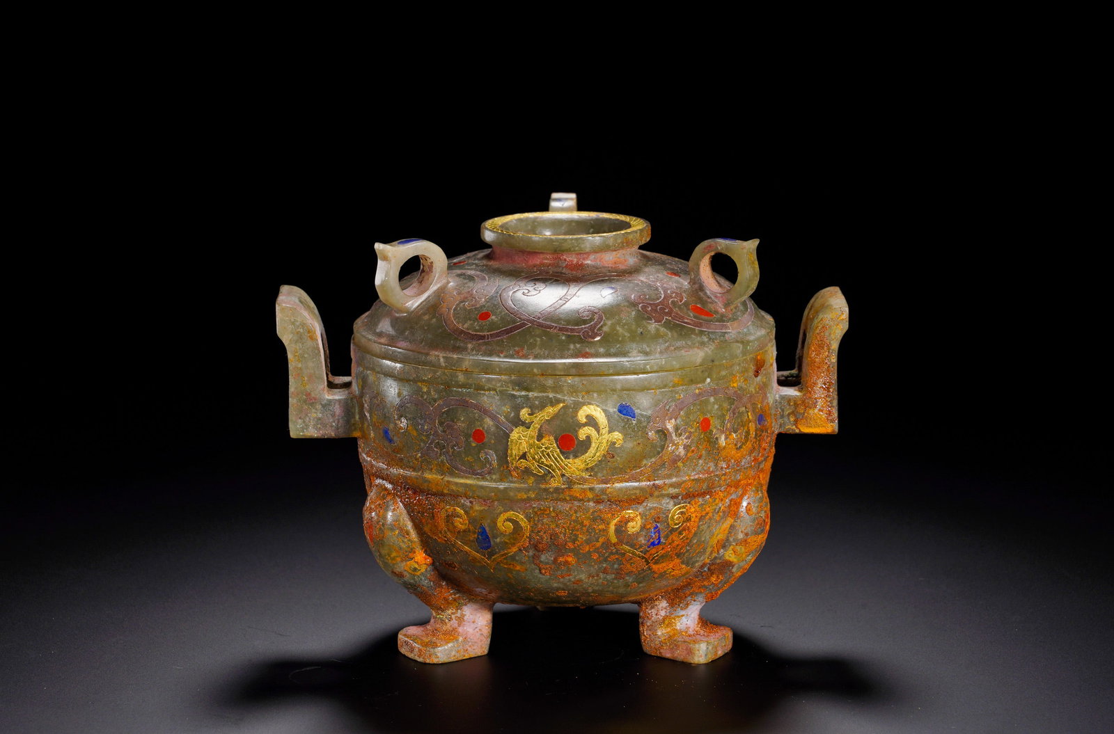 HAN DYNASTY HETIAN JADE INLAID GOLD AND SILVER TRIPOD: Height:11cm (4.33in) Width:15cm (5.91in) Weight:540g(1.19lb)Jade ritual vessel modeled after bronze ding, equipped with lid, two upright handles and three beast feet. Phoenix scroll patterns delineate