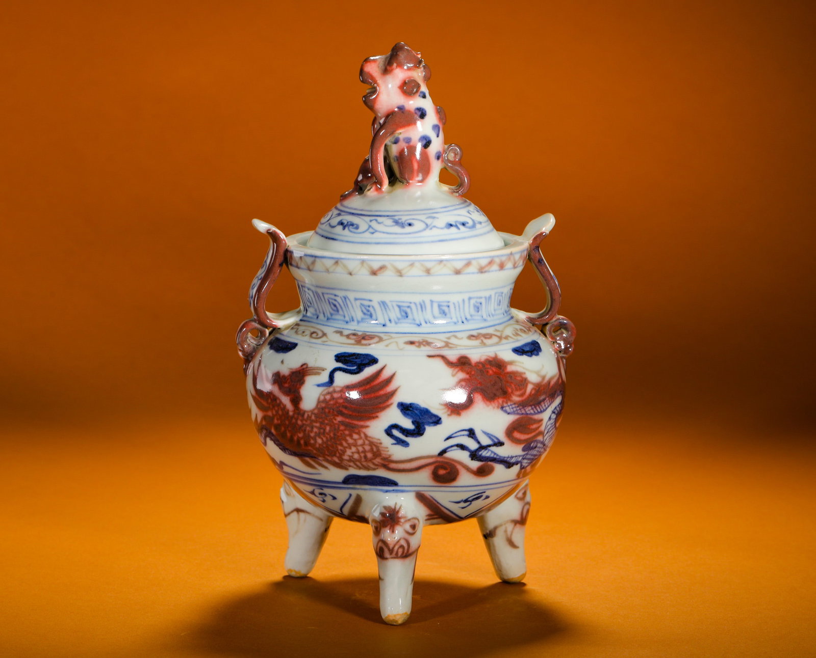 BLUE AND WHITE UNDERGLAZE RED DRAGON AND PHOENIX THREE-LEGGED INCENSE BURNER OF THE MING DYNASTY: Height:22cm (8.66in)Width:15cm (5.91in)Weight:1030g(2.27lb)Antiqueblue&underglazeredtripodcenser, dragon-phoenixauspiciousmotif, incenseritualporcelain.