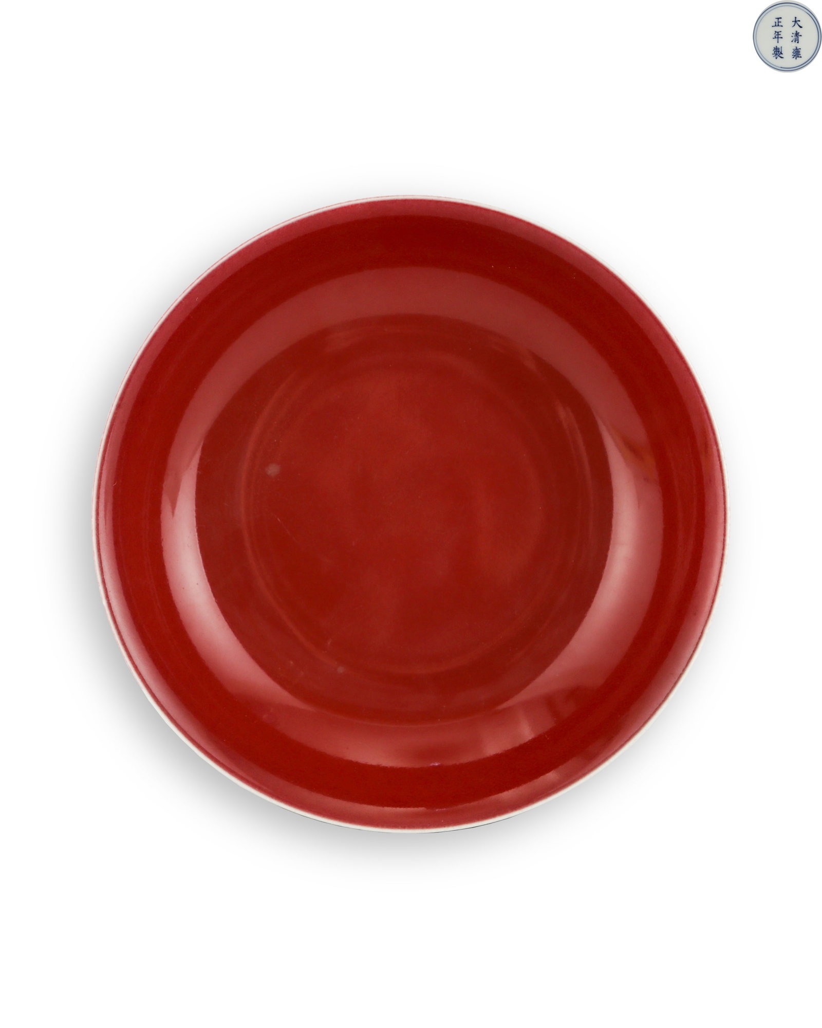 THE RED GLAZE PLATE OF THE QING DYNASTY'S YONGZHENG SACRIFICIAL CEREMONY: H:4.5cm W:20cm Official sacrificial red glaze plate of Yongzheng reign, Qing Dynasty, wide flared mouth and shallow belly with neat ring foot. The whole interior is fully covered with sacrificial red 