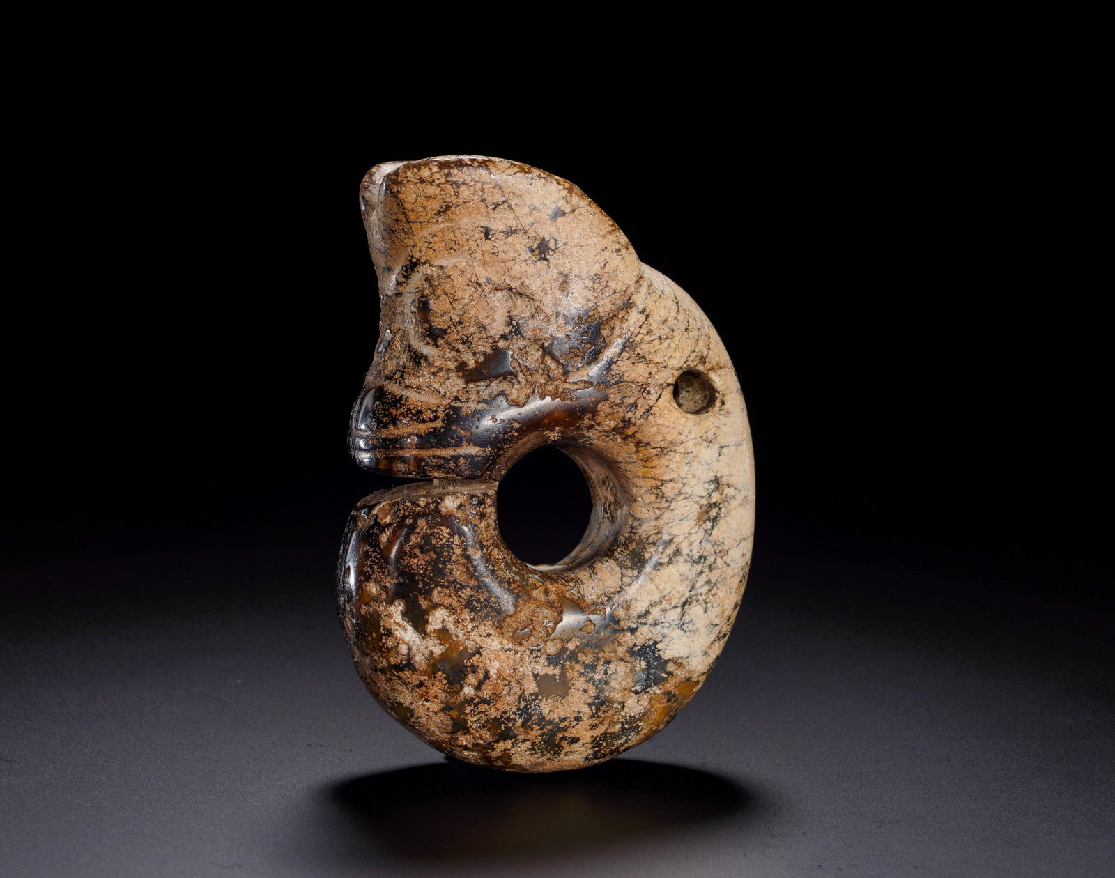 RED MOUNTAIN CULTURE JADE PIG DRAGON: Height:10cm (3.94in) Width:7cm (2.76in) Weight:300g(0.66lb)The C-shaped coiled jade ornament features pig-like head with protruding snout and round eyes, hollow center and suspension hole on back. Nat