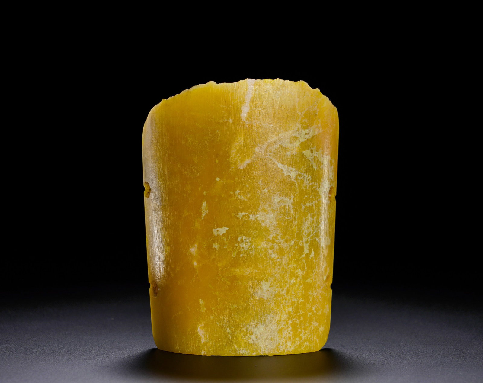 RED MOUNTAIN CULTURE YELLOW JADE ARMBAND: Height:9.2cm (3.62in) Width:6.45cm (2.54in) Weight:80g(0.18lb)The yellow jade tubular ornament with side perforations for binding. Natural white weathering patina spreads over surface. Tubular jade fi