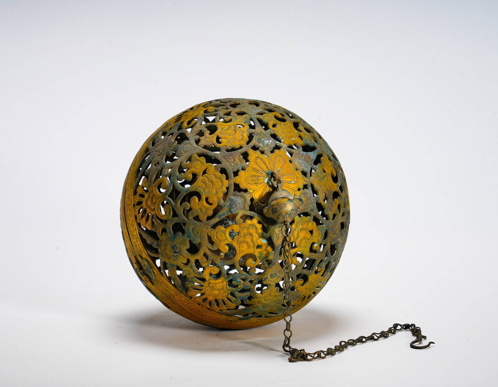 BRONZE GILDED HOLLOWED-OUT SACHETS OF THE HAN DYNASTY: Diameter:21cm (8.27in) Weight:860g(1.90lb)Hollow bronze ball fitted with suspension chain, openwork floral scrolls. Inner gimbal balance mechanism ensures incense bowl stays horizontal. It served as a