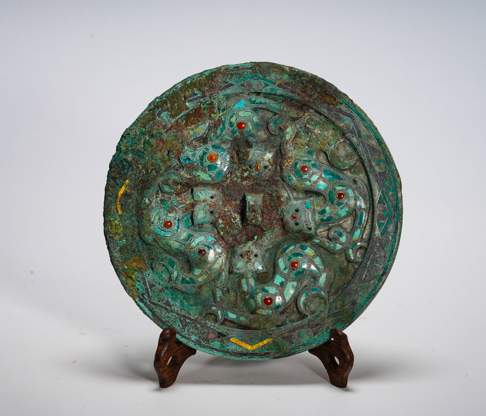 ANCIENT HAN DYNASTY COPPER-INLAID TURQUOISE SNAKE PATTERN MIRROR: Diameter:19.5cm (7.68in) Weight:940g(2.07lb)Circular bronze mirror with raised relief five serpents. Turquoise scale mosaic, gemstone eyes, geometric border ornament. Serpent symbolizes netherworld gu